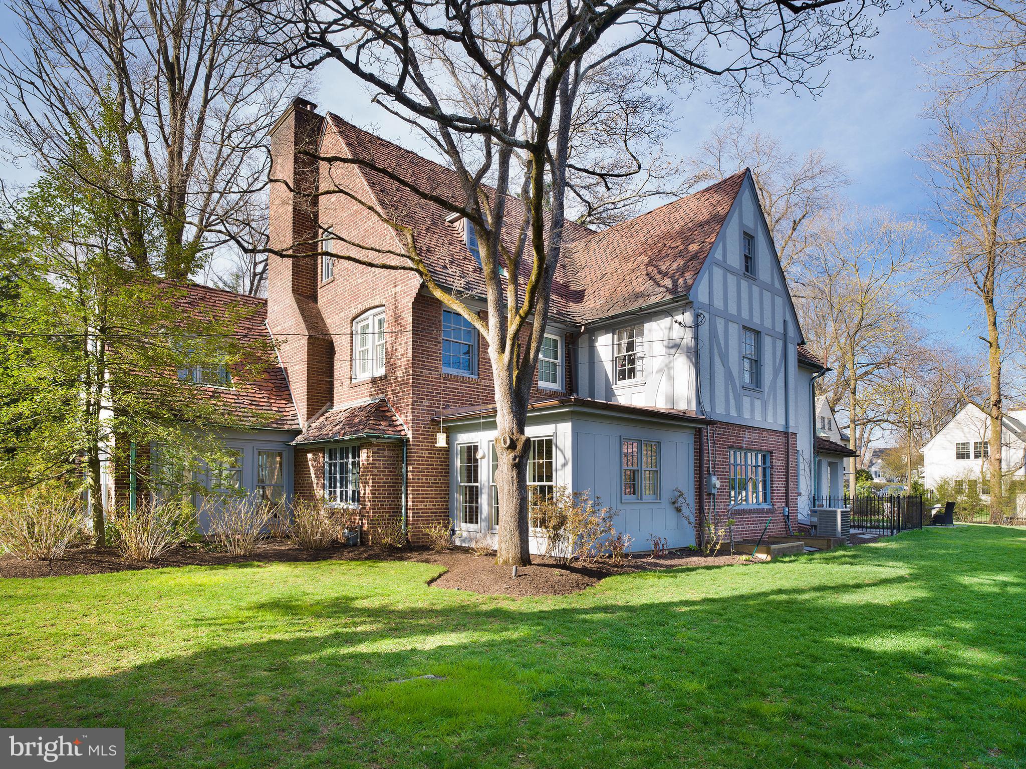 Located in the highly sought after town of Bryn Mawr, this completely renovated, move-in ready six-bedroom, three-and-a-half-bathroom brick Tudor home is sure to impress.
As you make your way up the gated driveway, you are immediately awestruck by the yards of flat green grass, expertly manicured hedges, and lush greenery. Enter through the grand wooden front door and you are immediately welcomed by a vast hardwood foyer that guides you throughout the main floor. Immediately to your left sits your formal dining room perfect for hosting your next dinner party with friends and family. Across the hall is the expansive living room, complete with an elegant fireplace accented with a wooden mantle. Directly attached to the living room is the first sun room on the main floor, detailed with oversized windows and sweeping views of the grounds. Nestled in the back of the home is the custom gourmet eat-in kitchen that features sleek quartz countertops and island, a 48” gas range oven, five-star stainless steel appliances, a plethora of wooden cabinet space, custom built-in shelving, and a substantial walk-in pantry. The sun room directly off the kitchen is currently used as an eating area, boasting breathtaking views of the backyard, rustic exposed brick, and custom built-ins. Rounding out the first floor is a tiled multi-purpose space perfect to accommodate an in-home office, a mudroom/laundry room with custom built-ins and a walk-in closet for extra storage, and a convenient half bath.
Take the staircase of your choice to the second floor and find your way to the resplendent primary suite, complete with one walk-in closet and a second spacious wall closet. The private en suite bathroom features a stunning glass-enclosed stall shower, a double sink vanity, and expertly detailed tiling. Three additional suitably sized bedrooms can be found on this floor, including a secret playroom connected to one of the bedrooms, which enjoy the use of a full hall bathroom with a double vanity. The expansive third floor of this home hosts two bedrooms, with one bedroom large enough to serve as a second primary suite with two walk-in closets. Both bedrooms enjoy the use of a convenient full hall bathroom with a stand up shower.
The commodious lower level of this home is fully finished, complete with a play area, a home gym, and ample storage space. The fully fenced-in yard of this charming home hosts a picturesque tree house, an oversized shed, a rear patio perfect to host a barbecue, and yards of rolling green grass. This home is complete with an attached one car garage.
Advantageously located just a short walk on the quiet sidewalks from all things Bryn Mawr, you can take a leisurely morning stroll to endless shopping, restaurants, cafes, grocery stores, MOM's Organic Market, and more. This home finds itself in the Lower Merion School District, with many prestigious private schools in the area as well. Conveniently located between Route 30 and Montgomery Avenue, with easy access to I-476 and walking distance to local train stations, this home makes commuting a breeze.