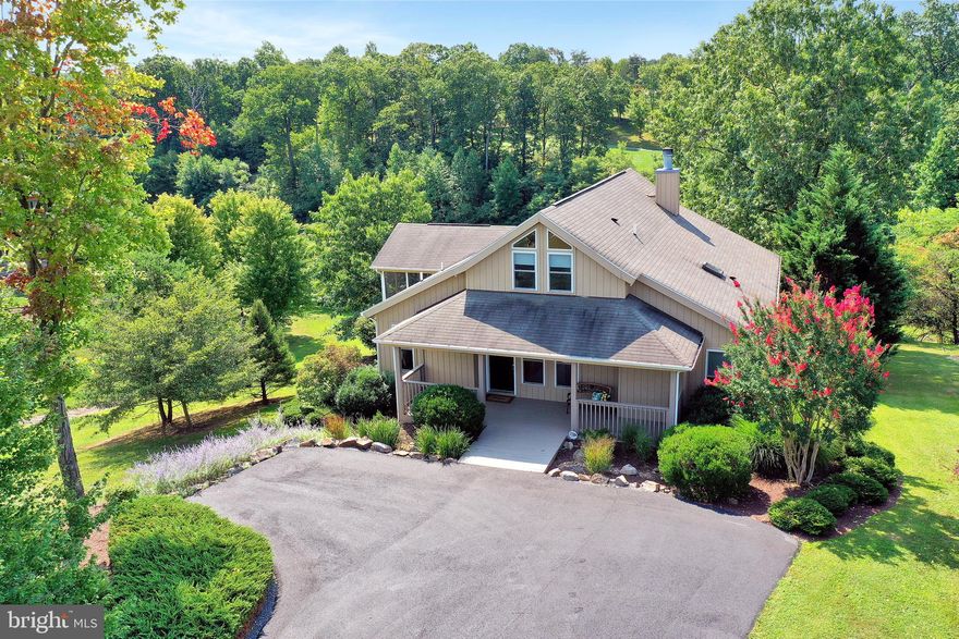 Absolutely stunning home located within The Woods Community! Resting on almost 1/2 acre of land, this well kept property offers views of the pond and the fairways of Mountain View Golf Course. Interior features include 3 Bedrooms on main level with 2 full bath including the Master Suite with walk-in closet and private bath with soaking tub and separate shower. Perfect for entertaining, you will find an open space featuring a Great Room with floor to ceiling windows, cathedral ceiling with beams, and stone fireplace which features a fan to provide heat through the whole room. Adjoining the Great Room is the Dining Area and Gourmet kitchen with breakfast bar, built-in microwave, and upgraded cabinetry and counter-tops. Walk out to the large house length deck off the rear or sit and enjoy the peaceful serenity from your screened in porch perfect for rainy days! Upstairs is a loft area which overlooks the great room and could function as a potential 4th bedroom with half bath. The lower level comes unfinished ready to make your dream entertainment space! Imagine finishing the space with a custom bar backing the walk out area to the rear yard with views of the water!! Home comes fully wired for cable, sound system, and security system. Home also comes with a Class A transferable Membership to The Woods Resort and all the amenities including golf. Transferable for up to 1 year at a discounted initiation and annual fee. This is a true gem which has been impeccably maintained!