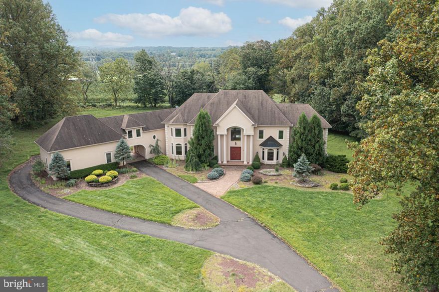 Zaveta Custom Built French Provincial home in the desirable Autumn Trace community. Located on 4.3 acres in Solebury Township, the property is within a small enclave of charming estates sharing long distance views and mature landscapes. Excellent opportunity to realize the potential in this home. Majestic two-story foyer with dual sweeping staircases sets the stage for the expansive first floor. Hardwood floors grace the spacious family room with two story floor-to-ceiling windows allowing for views of the privatized backyard. An impressive fireplace with two-story custom mantle is the showpiece of the room. Steps away, the sunken living room provides an opportunity for entertainment and gatherings. The adjacent billiards room offers access to the exterior deck. The contemporary kitchen is spacious and offers a stone wrapped fireplace, granite topped island and butler’s pantry. A formal dining room also shares the two-sided fireplace and features custom moldings and back lit ceiling. The main floor also offers a playroom/office and mudroom with laundry. The second floor main bedroom suite is embellished with custom moldings and features an oversized ensuite bath with jetted soaking tub, walk in shower with rain head and radiant heated tile floors. There are four other additional generously sized bedrooms with attached full baths. The au pair suite is located above the garage and has a private entrance. A finished walk out lower level provides another full bath and convenient changing room for the pool, an elaborate theater room with full surround sound, and an extravagant wine bar. The exterior offers extensive hardscaping with an array of shrubbery and trees, and an in-ground pool with travertine decking. Extensive exterior terraces and patios. Porte cochere leads to the ample three car garage. Excellent opportunity for an estate property in Solebury Township since replicating this square footage in a new home would cost substantially more!