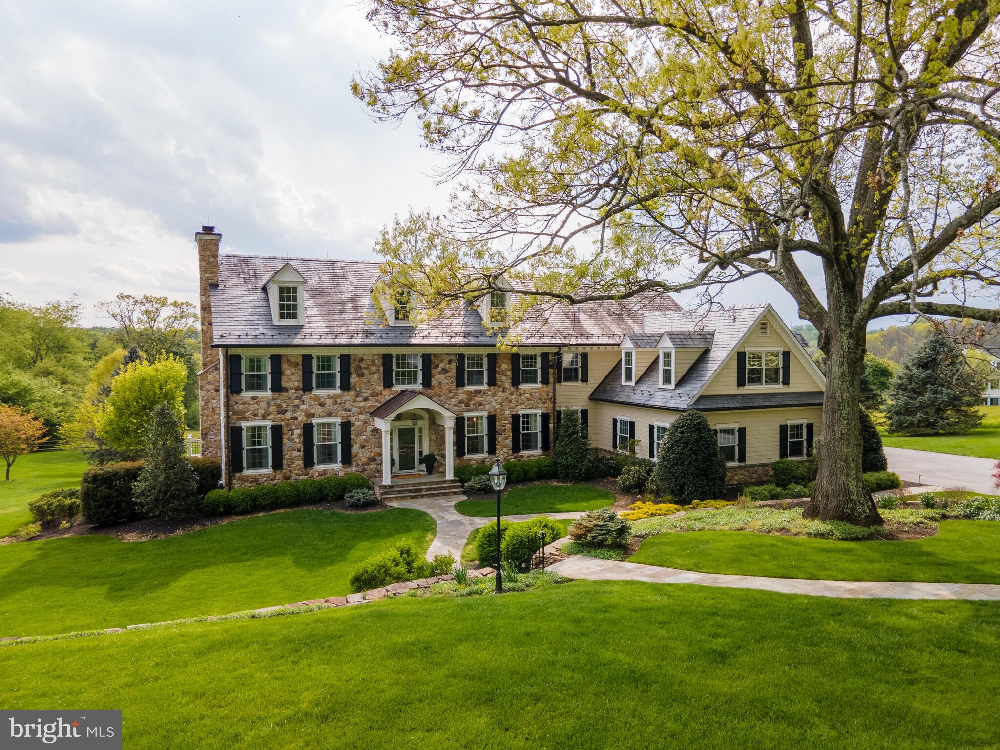 DECIDE NOW! This absolutely magnificent home built by Phil Ciusano sits on 2.5 acres and backs up to 170 acres of preserved land managed by Brandywine Conservancy. Waterloo Mills Preserve is out your back window. Since buying in 2017, sellers updated the house to the highest standard. On the exterior, all stucco was removed & replaced with Hardie Plank. The front stone wall was removed, waterproofed behind the wall & the stone returned to the wall. All work completed & guaranteed by Advance Plastering Company. Sellers also repaved driveway, rebuilt the deck w/ tile floor & glass railings, added a whole house generator, added a hot tub, installed flagstone walks, replaced all shutters& gutters, added lighted columns framing the driveway, repaired some slate roof tiles, covered mis-matching brick on the chimneys with stone matching the stone at the front of the house, professionally landscaped the property including nursing the specimen pin oak in the front, added trees, shrubs & bushes. This is just on the exterior. Let’s move into the house,sellers replaced all HVAC equipment (3 zones), gutted and rehabbed the kitchen, installed new Cherry Wood floors t/o, remodeled all baths- new vanities, toilets etc, replaced interior hollow-core doors with sold-wood doors & hardware, added A/V wiring and equipment, had Closet-Works customize closets, installed remote-controlled electric Hunter Douglas Silhouettes in Fam Rm & kitchen and replaced lower level carpet. Enter the foyer via the new flagstone exterior walkway and be greeted with Crema Marfil Honed Marble Flooring (Premium) - in the foyer, hall closet and formal powder room. The curved staircase has newer carpet on top of recently refinished stairs. From the foyer, on the left is the formal LR w/ gas fireplace and egress to the back tiled deck. From the foyer on the right, is the formal DR with trey ceiling & storage closet for table leaves. Keep going into the completely gutted kitchen boasting 42” custom Century Wood cabinets, granite tops, sub-zero refrigerator, GE profile double wall oven, two microwaves, 5 burner el cook top, SS hood, kitchen aid dishwasher, neutral tile back splash & pocket doors which were modified to accommodate newer cabinet layout. Views from the room are spectacular as the kitchen faces the conserved land. The 2-story family room is off the kitchen where the wood burning stone surround fire place is just as gorgeous as the views from the wall of windows overlooking the conserved acreage. Additional FR features are the built-ins including the beverage frig & bar & egress to the deck. The first floor laundry room boasts large stall shower, custom cabs for storage & w/d. There are 2 powder rooms on this level as well as a formal office/library with custom wood built-ins.Gporgeous views from the office are of the back acreages. The 2nd level finds the 5 bedrooms. The main BR has a fireplace, custom closet for him & his own powder room. Behind this 3rd powder room is the main bath which was demolished in 2017. In its place is an oversized stall shower, private loo, new vanity & electric radiant floor. Keep going to find the 2nd floor laundry w/ stackable and a pocket door into the converted guest BR currently is use as a dressing room. It can be returned to a BR. Continue along the hallway to more BR's and full baths also gutted. In the J&J bath, the sellers installed an extra-length tub. Follow the hallway to the loft with built-ins which overlooks the family room. Keep going around to the 5th BR suite (now an office) complete with full bath & new shower door, vanity & loo. Entry to the floored attic is dedicated & boasts an HVAC unit that manages the main & 5th BR. Lower level is finished, has new carpet & egress to the newer patio housing the hot tub. Taxes $22,412. House in Chester Cnty, TESD. Mailbox on Harrison Dr in Del Cnty-Hence, mail delivery to Newtown Sq due to mailbox location.SQ FOOT OF 6,966 INCLUDES 970 FINISHED SQ FT BELOW GRADE.