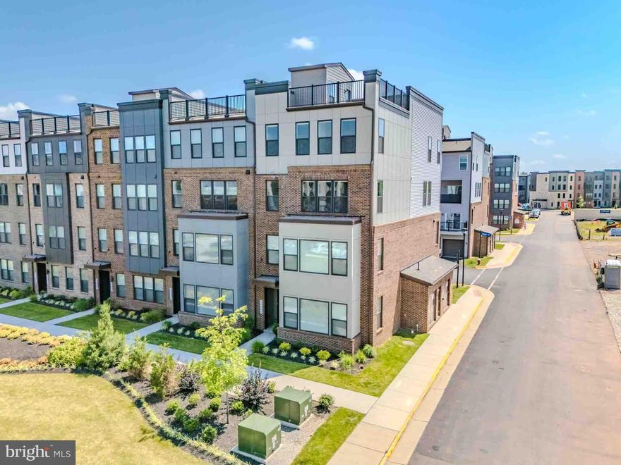 END-UNIT | ROOFTOP TERRACE | ABUNDANT NATURAL LIGHT | HOME OFFICE | METRO ACCESS | LUXURY FINISHES

Step into a home that truly stands apart in Ashburn Station. This stunning three level, end-unit residence blends modern design with effortless livability, offering 3 bedrooms, 2.5 baths, a dedicated home office, a spacious primary suite, and a private rooftop terrace that elevates everyday living.

Perfectly positioned with a northeast exposure, the home is drenched in beautiful natural light from morning through evening, creating bright, inviting spaces throughout. The main living level features an open-concept layout designed for both connection and comfort, anchored by a chef inspired kitchen with a statement center island, brushed gold hardware, stainless steel appliances, and a generous walk in pantry. The seamless flow into the dining and living areas makes hosting easy, while the covered balcony just off the dining space is ideal for morning coffee or winding down at night.

Upstairs, the primary suite offers a true retreat with a boutique-style walk-in closet and a spa inspired bath featuring dual vanities. Two additional bedrooms and a full bath provide flexibility for guests or additional living space, complemented by upgraded motorized window treatments and designer lighting.

The rooftop level is the showstopper with a private outdoor escape perfect for entertaining, relaxing under the stars, or taking in sunset views over Loudoun County. It’s a rare feature that transforms this home into something truly special.

All of this just minutes from the Ashburn Metro, with easy access to shopping, dining, and everyday conveniences. Stylish, light-filled, and move in ready. This is a home that lives as beautifully as it looks.