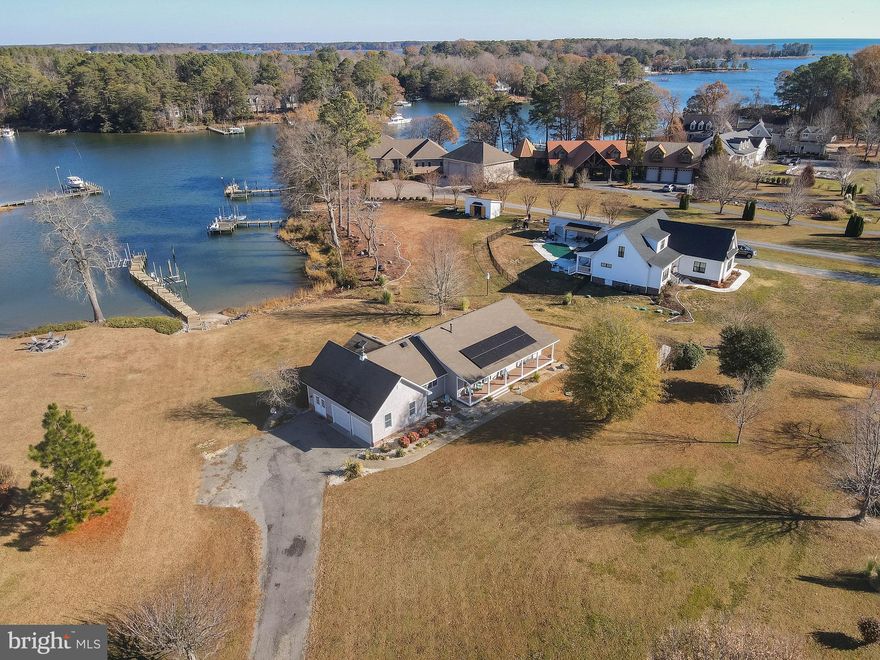 Located on protected Crane's Creek, this sailboat-depth, waterfront property is ready to move in and enjoy! Inviting hardwood floors welcome you into the family room, foyer, office (with built in book shelves), dining and kitchen. Amazing views from all the open spaces, as well as a private balcony off the primary! The family room is warmed by a stone hearth fireplace, which can also be enjoyed from the dining area. The kitchen is nicely appointed with lots of cabinets and counter space, gas cooking and a breakfast bar. Two pantries for your convenience. The dining area overlooks a lovely sunroom, with amazing views of your shared dock, private boat lift (with power & water) and private sand beach! Wake up to an amazing sunrise from your primary suite, complete with lovely bath and walk-in closet, and sip your favorite beverage from the primary deck! Two additional bedrooms and full bath each have carpet, closets and a shared hall bath. There is a conditioned bonus kitchen, complete with stove, refrigerator and storage. A two-car oversized garage (with pull down attic), a whole-house generator, skylights, conditioned crawl space and solar energy completes the picture! Located in the sought-after neighborhood of Cranes Creek Harbor, just minutes to the Bay or a quick drive to Kilmarnock. Don't miss the opportunity to make this one yours, just in time for the New Year!
