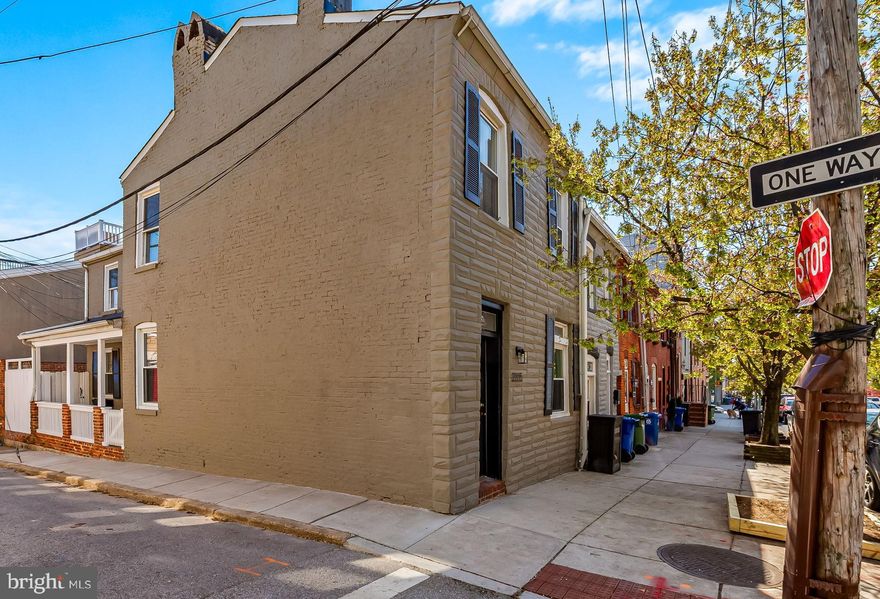 This charming end-of-group 16' wide home is desirably located on a Canton tree-lined street steps from Patterson Park. The creatively renovated property offers a light-filled main level open floor plan with an expansive living, dining, and kitchen area, an adjoining half bath, and large laundry and utility rooms.  The second level features a dramatic primary bedroom with vaulted ceiling, built-in cabinetry, and spacious closet. There is an additional bedroom and full bath as well. Focal points of the residence include eye-catching brick accent walls, wood floors, track lighting, 3 ceiling fans, wood kitchen cabinets, stainless steel appliances, granite countertops, French doors, and a covered side entry and porch leading to a private enclosed brick patio.  Recent updates include a new roof (2024), new hot water heater (2025), new HVAC with extended warranties (2021), new gas range (2021, laundry room redo (2025), and extensive exterior and interior painting (2025). Located within proximity are an abundance of restaurants, bars, coffee shops, shopping centers, cultural events, the Johns Hopkins and U of M campuses, the waterfront promenade, various neighborhoods, and major highways, schools, and institutions.