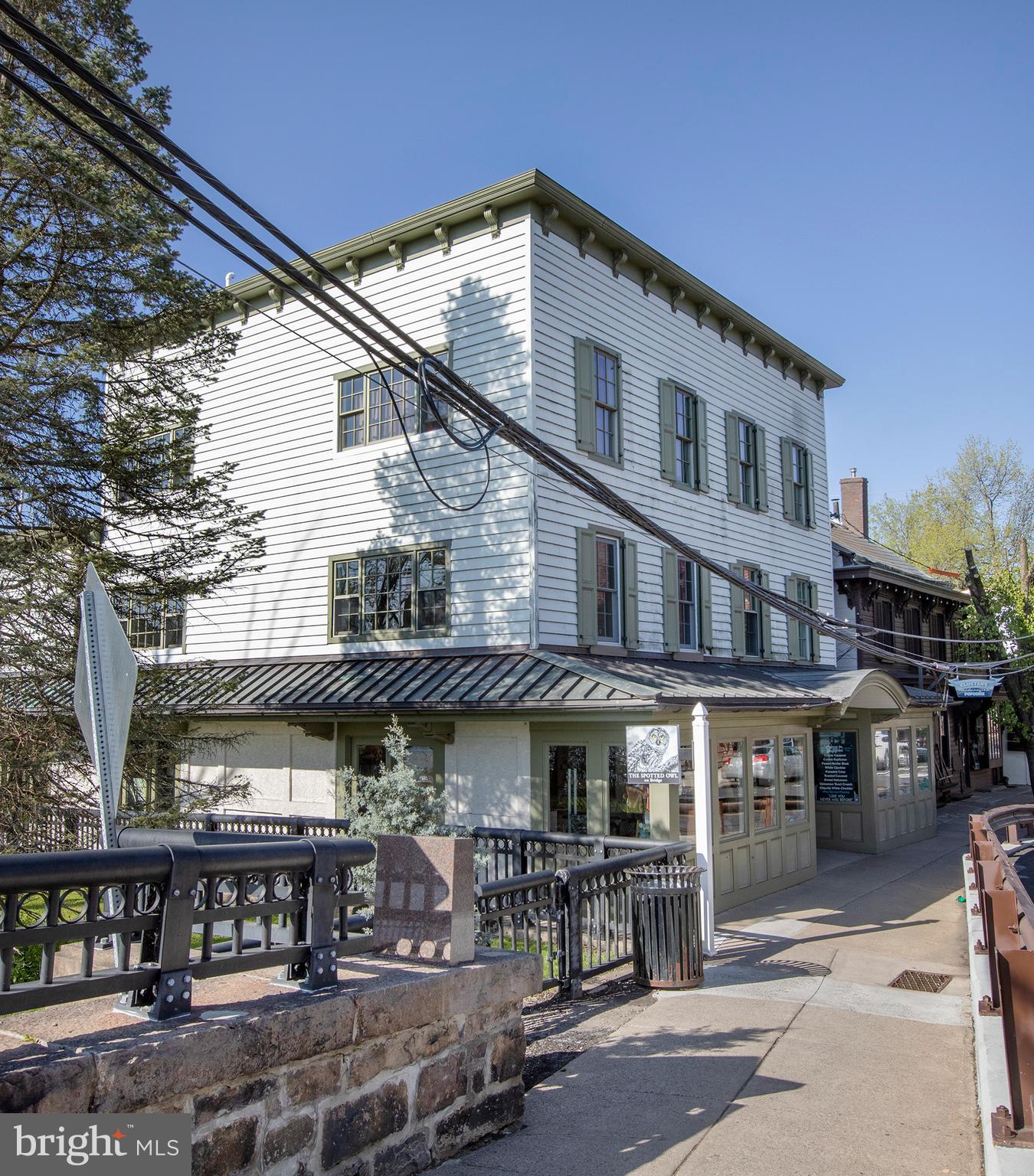 Perched at the grand entrance to New Hope from the iconic bridge from Lambertville, NJ, this fully leased, 6 unit investment property underwent a full scale renovation circa 2006 and features two street level retail stores and four apartments. With an excellent history of tenancy, this prime location has always drawn reliable commercial shops benefiting from some of the highest foot and vehicle exposure available in town. Located across the street from Starbucks and Dunkin' Donuts, approvals were previously granted for an expansion of 750 SF of the main level commercial space. Adjacent open-space (with sculpture) is owned by the bridge commission and is fenced off from the public, providing plenty of buffer for the premium apartment views of the river.
