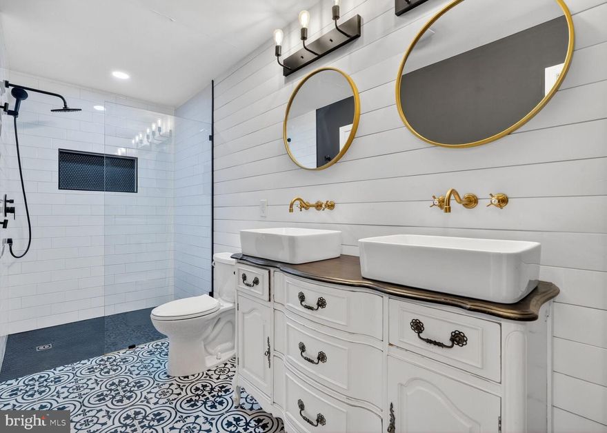 Spacious and beautifully updated one-bedroom condo offering 1,053 square feet of comfortable, light-filled living space. A covered entrance welcomes you into a large tile-floored foyer, setting the tone for this well-designed and inviting home. The main living area features an open living and dining space anchored by a cozy wood-burning fireplace—perfect for relaxing evenings or entertaining guests. A bright sunroom with soaring cathedral ceilings and a wall of windows fills the home with natural light and opens to a covered deck, creating an ideal spot for morning coffee or unwinding at the end of the day. The generously sized kitchen offers ample cabinetry and workspace, while the oversized bedroom includes a walk-in closet, providing excellent storage. The remodeled bathroom is a true highlight of the home, showcasing a sleek glass-enclosed shower, dual vanity, and luxurious heated floors—bringing a spa-like experience to your daily routine. Additional features include a full-size washer and dryer for added convenience. Residents enjoy a pet-friendly community with amenities such as a swimming pool and abundant parking. Ideally located near shopping, dining, and everyday conveniences, with easy access to major commuter routes and just 6 miles to the Shady Grove Metro. Move-in ready and beautifully updated—this is a fantastic opportunity to own in a desirable location.