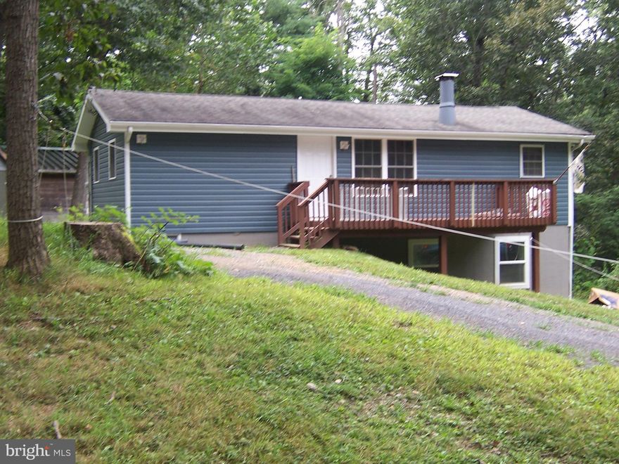 Mountain Retreat with Rustic Charm & Modern Updates Escape to your own wooded haven with this charming mountain home nestled on a serene, tree-lined lot. Surrounded by nature and fresh mountain air, this property offers the perfect blend of peaceful seclusion and functional living. Property Highlights: Wooded Lot & Fresh Exterior: Enjoy privacy and natural beauty with mature trees and brand-new exterior siding that enhances curb appeal. Welcoming Front Porch: A cozy spot to sip your morning coffee or unwind in the evening. Open-Concept Living: The kitchen flows seamlessly into the dining and living areas, all under a stunning cathedral ceiling that adds space and light.
Main-Level Comfort: Two spacious bedrooms and a full bath provide convenient single-level living.
Finished Lower Level: Includes a second full bath, a large recreational area perfect for entertaining or relaxing, and ample storage space for all your gear. Detached Garage & Workshop: A generous garage with extra room for tools, hobbies, or outdoor equipment—ideal for DIYers and adventurers alike.