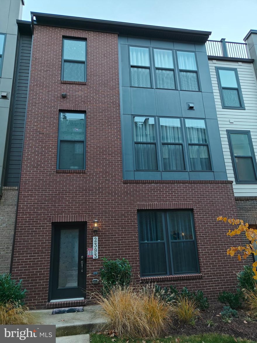 Blocks from silver-line metro Station. Beautiful 3-year new 2-car-garage townhouse with unique floor plan. 9-10 feet high ceilings, large windows, full of lights.  3 bedrooms, 2 full baths and 2 half baths. Close to the area’s best shopping, dining, entertainment, largest employers and features immediate access to the Dulles Access Road, Innovation Center South Metro Station and Dulles International Airport. Step inside the Hayworth, and immediately fall in love with this spacious and functional townhome. The lower level features a spacious 2-gar garage and sundrenched bedroom with a half bath, perfect for home office or library. As you go up the stairs, a stunning main level opens up flowing from the family room to the kitchen and eating area. Imagine sitting around the fireplace in a the family room, illuminated by tall windows and entertaining in the lux kitchen complete with the latest finishes and massive 12' quartz island. Owner's suite accompanied by two walk-in closets and bathroom with the latest finishes. 
Kitchen desk and living room wall mirror convey.  Owner agent.