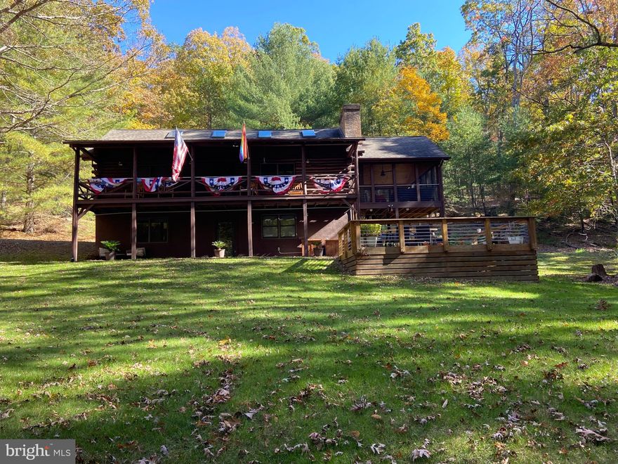Exceptional property in the Mill Gap area of Lost River.  Three level log house with 3 bedrooms, 3 and 1/2 baths.  Loft bonus room overlooking the kitchen/dining/ living area. Two wood burning fireplaces.  Large cozy open concept living with vaulted wood ceilings, covered porches, and a screened porch.   High end baths with heated tile floors. Laundry room with washer/dryer. Kitchen with Bosh appliances and prep/breakfast island.  Gas range, HVAC, hot tub with deck and firepit.  Large detached garage that could be transformed into additional living space or space for hobbies/crafts.
 Honeywell Smart Control System to control HVAC via telephone app, High Speed Internet/Solid wood panel doors throughout house.  All full bathrooms have heated tile floors with programmable thermostats.  All bathrooms have rain shower heads.  UV Water Purifier.  Underground propane tank.
 This house was completely gutted and remodeled in February of 2019.  The design and renovations were guided by William DeMaio, architect of Denver, Colorado. 
 This property is easily accessible on a well-maintained road in the Lost River Valley Subdivision in Mill Gap. The association is well funded.  This property would be an excellent weekend rental.
 
There is a Fact Sheet available in documents as well as a plat of the property.
