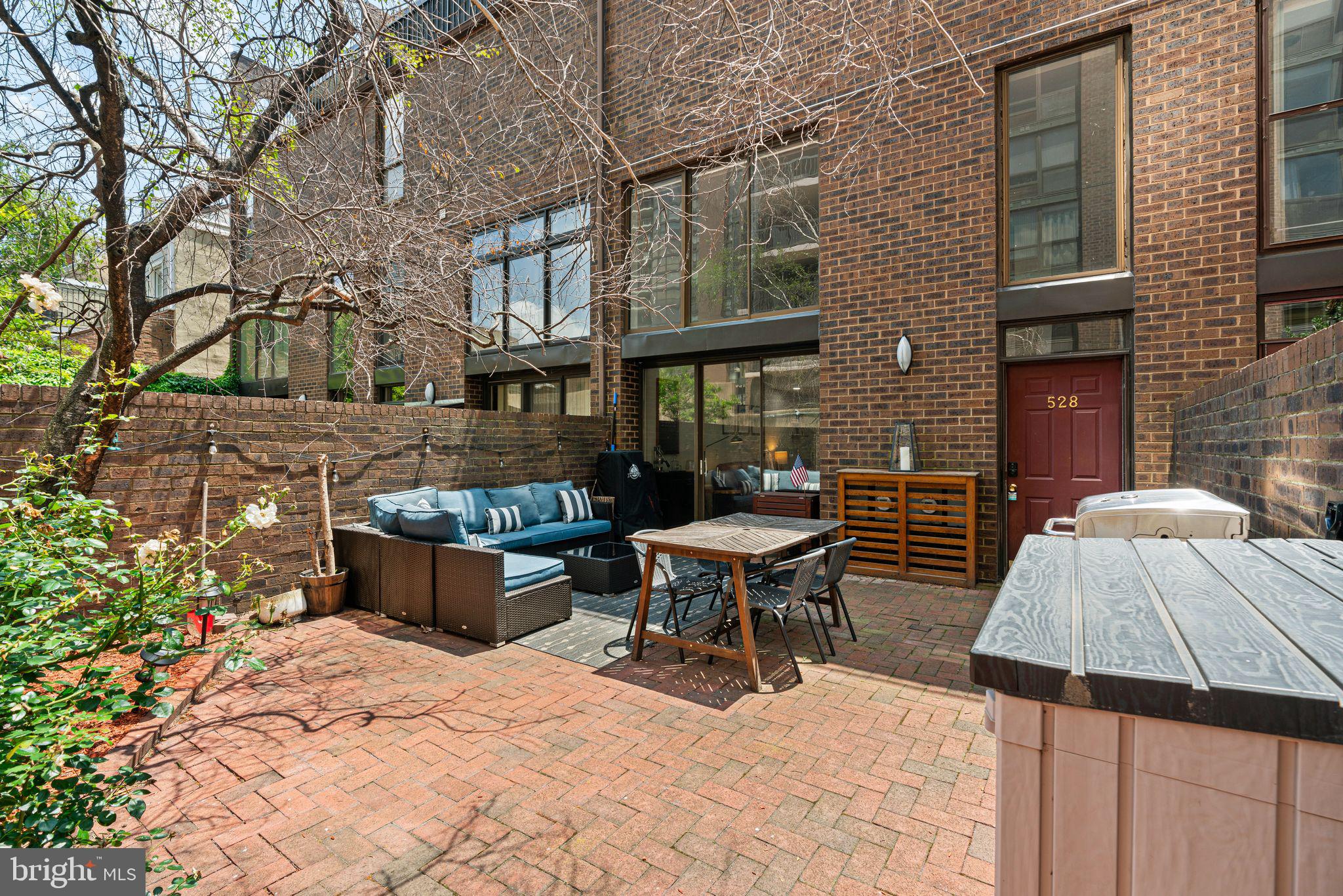 Picture yourself strolling down your own serene brick walkway—tucked away in the heart of historic Society Hill. It leads to one of the rarest city features: a private, oversized brick patio. Whether it’s your morning coffee, an evening glass of wine, or a weekend gathering with friends, this outdoor space instantly feels like your own urban oasis.
Step through sliding glass doors into a soaring two-story living room filled with natural light from double-height windows. The connection between indoor and outdoor living is seamless, bringing comfort and airiness to every moment. Just beyond, the open-concept kitchen is fully updated with quartz countertops, gray cabinetry, and stainless gas appliances—ready for everything from quick weekday meals to leisurely weekend breakfasts.
Living here means being a short stroll from some of the city's most beloved spots. Grab a latte at Bloomsday Café, catch live blues and bourbon at Twisted Tail, or enjoy a game night with wine at Queen & Rook. Groceries are simple with Whole Foods and The Fresh Grocer just a few blocks away.
Upstairs, a sun-filled loft offers flexible space perfect for working from home, reading, or creative pursuits. The spacious primary suite is tucked away for privacy and features a spa-like bathroom with both a deep soaking tub and a sleek stall shower. On the main floor, a second bedroom and full bathroom provide versatility for guests, a nursery, or a dedicated office.
Additional features include an in-unit laundry hookup and secure, guaranteed monthly parking at the nearby Independence Place garage. And when it’s time for dinner out or a celebratory night on the town, you’re just steps from acclaimed restaurants like Zahav, Provenance, and ESO Ramen Workshop.
Whether you’re a young professional looking for modern design and walkability, a family needing smart use of space, an empty-nester seeking comfort without compromise, or an investor searching for the perfect pied-à -terre, this home adapts to your lifestyle.
This isn’t just a place to live—it’s a better way to live. Thoughtfully updated and located in one of Philadelphia’s most iconic neighborhoods, this home offers historic charm, modern ease, and everyday inspiration.