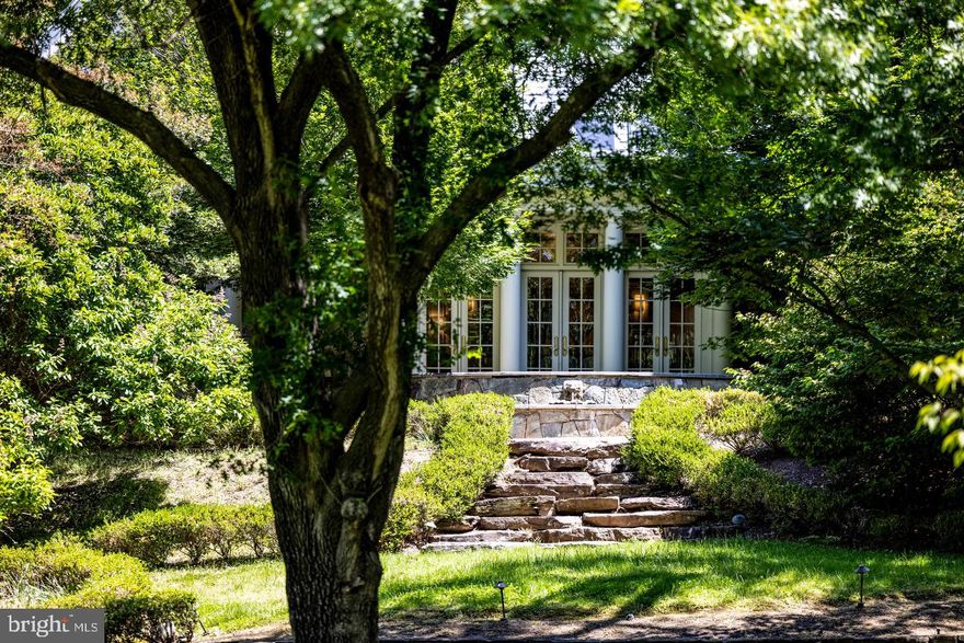 Welcome to Stone Wood Manor—set on a pristine 5+ acres with a gated entrance, tennis court, full gym, tree-lined driveway, and a two-story guest house complete with its own kitchen. A pool can be added. The drive reveals a stately manor surrounded by manicured lawns, cascading fountains, vibrant gardens, and a tranquil pond beside the tennis court. Designed for intimate living and entertaining, the interiors glow with natural light, showcasing intricate millwork and six elegant fireplaces. The gourmet kitchen—anchored by custom cabinetry, chef-caliber appliances, and its own wood-burning hearth—flows into a cheerful breakfast room and a soaring two-story great room framed by walls of glass. The Versailles-inspired grounds, envisioned by landscape artist Charles Owen, are enchanted with stone fountains, French wrought-iron gates, and pea gravel paths. Minutes from Tysons Corner, McLean, and Washington, D.C., Stone Wood offers refined living in a resort-like setting—an oasis of elegance and tranquility.
