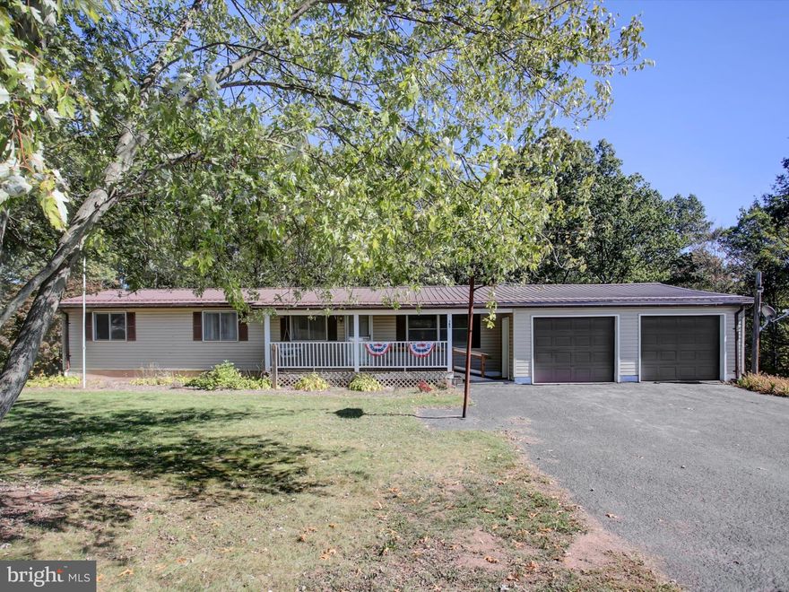 BIG VIEWS!  Take in the picturesque country & mountain views from the front porch & solitude of the wooded backdrop from the rear deck.  This 3 bdrm, 1 1/2 bath ranch style home situated on a 1 acre lot offers a huge LR, updated full bath and full walk-out to grade basement.  24'x24' area in basement is partially finished w/paneled walls & drop ceiling. Other updates include vinyl siding, some replacement windows & metal roof.   Although a little dated, this home is clean and has been very well maintained!  If you like garage space this is the home for you with 2 car attached garage & 2 car detached garage plus additional storage sheds.  This is a manufactured home built in 1975, which means it will require at least 20% down payment or cash.  Take a look at this home & you will feel "At Home".