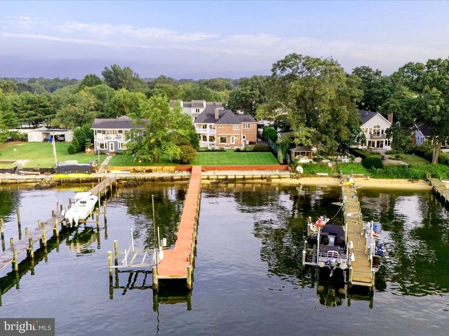 Exceptional Waterfront Retreat nestled along the shores of the Magothy River! Experience luxury, tranquility and the best of waterfront living with 75 feet of pristine shoreline, an updated pier, boat lift, and a scenic stone path along the bulkhead. Fill the days with boating, fishing or simply relaxing and enjoying the calm ambiance.  Each day can begin and end watching the glow of the sun reflecting off the serene waters of the Magothy River. Set on nearly one-third of an acre, this four-bedroom, 2.5-bath home features an open-concept design with sweeping river views from almost every room and abundant natural light throughout. The open concept design seamlessly connects the indoor and outdoor spaces, with each space providing the perfect setting for both entertaining and unwinding.  Enjoy the warmth of the 3 sided fireplace in the Family room while watching the activity on the water. The chef’s kitchen is equipped with a spacious island, custom cabinetry, stainless steel appliances, tile backsplash and water views. The primary suite on the upper level offers two private balconies, breathtaking water views, and a spa-inspired bath with a cozy fireplace. 3 additional bedrooms provide plenty of room for family or guests. Head outdoors where the two spacious decks create an ideal settings for morning coffee or sunset cocktails, while meticulously landscaped gardens lead you down to the water’s edge. The private pier awaits your next adventure, making this property a haven for water enthusiasts. Launch some kayaks or head out on a long cruise on the Magothy River with easy access to the Chesapeake Bay and beyond. Located in the Blue-Ribbon Broadneck School district, walking distance to The Point Restaurant and just 5 miles to downtown Annapolis and Severna Park. Convenient to Baltimore, BWI, Ft. Meade/NSA and Washington, DC. You literally have the best this region has to offer in a 30-mile radius. Welcome Home!