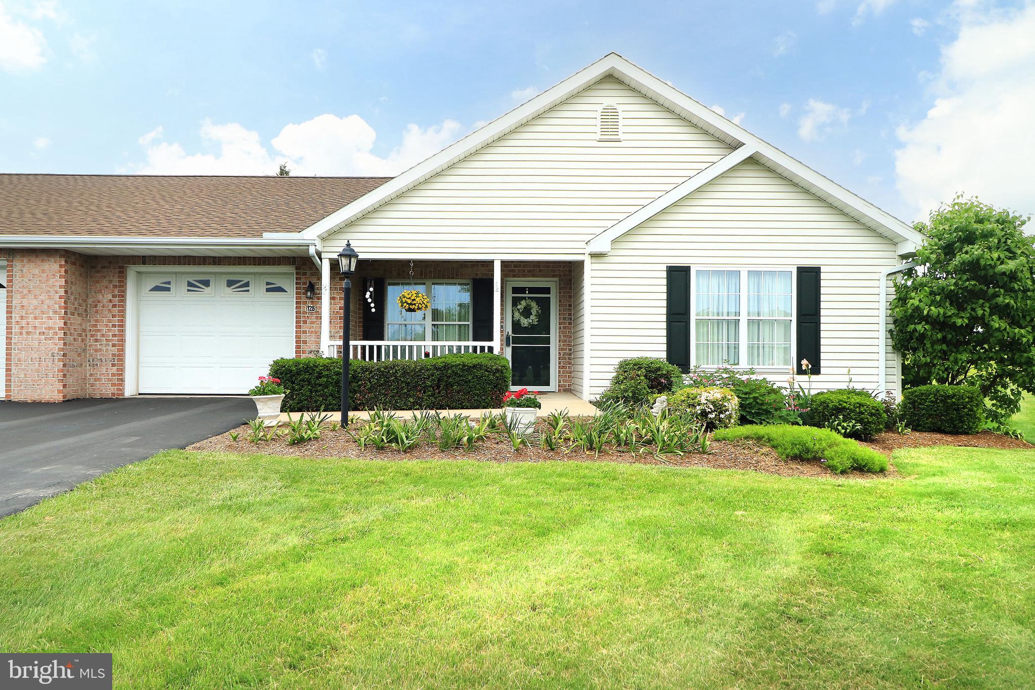 Lovely, meticulously maintained two bedroom, two bath condo in the sought after Penns Manor neighborhood. Enjoy care-free living in this sizable one-floor condo. Be welcomed by pretty flower and landscaping beds and a wonderful front porch. Enter into the living room, which features a large window, hardwood flooring, and a gas fireplace. The open concept floorplan has an ample sized dining room with hardwood floors that flows right into the living room on one end and on the other end into the spacious kitchen, which boasts granite countertops, a tile backsplash, and a breakfast bar with stylish pendants. The family room/den area is the perfect place to relax and take in the views of the backyard and gorgeous farmland and mountains in the distance. Coming in from the one car garage with storage above there is a mudroom area, a laundry room, and a large pantry closet. A spacious primary bedroom with wonderful views, ample closet space and a full bath with a shower unit and a sizable guest room that's next to the full hall bath complete the main floor. You'll love relaxing or entertaining on the huge composite deck taking in the views of the farmland, animals, and distant mountains. Penns Manor has a lovely clubhouse, so make sure you check that out, too. If you're looking for a beautiful setting, a move-in ready home on a culdesac, and care-free condo living in the country, this is the place for you!
