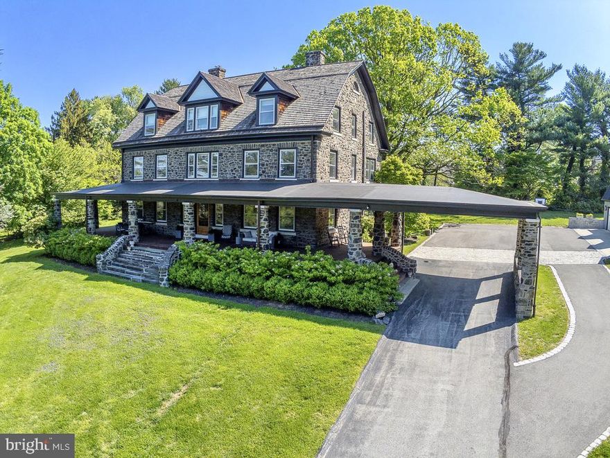 Welcome to this stunning and historic stone manor home set on a 3+ acre property in coveted Gladwyne.  Enter the long drive, through gated stone pillars, and arrive at the courtyard with covered entrance and impressive wrap around covered porch with views of the lush landscaping and extensive lawn and gardens that encircle and frame the property.  This architecturally distinctive home has been beautifully maintained and updated to meet the needs of today’s lifestyle while preserving the classic quality and character of the period.  All rooms are spacious and open, with wide hallways and  staircases connecting three full living levels.  Visitors are welcomed into the stunning Grand Foyer that opens into many directions. The Main floor offers a Living Room, a very spacious Family Room with fireplace, completely redesigned and renovated Kitchen with eating area, original Butlers Pantry with vintage cabinetry, Dining Room with fireplace,  a new full Bath with shower, and oversized windows in every room bringing in wonderful natural light.  The grand staircase leads to the 2nd floor with 5 spacious bedrooms and 3 stunning new baths.  The Master Bedroom features an exquisite new Master Bath, custom designed with the highest quality materials and fixtures. The Laundry Room is also located on the 2nd floor.  The Open staircase continues to the 3rd living level with additional Bedrooms, an office, a playroom, and an upstairs Family Room, all served by a hall bath.  A huge walk in closet on this floor provides ample storage.  The distinctive architectural features that define this home continue throughout all three floors, with beautiful hardwood floors, deep window sills and large windongws, and living space designed on a grand scale.  The basement is very spacious and features an outside daylight entrance into the mudroom, organized with cubbies and storage for everyday use, and featuring a double set tub sink and full bath with shower.  The detached 3 car oversized garage features a loft room ready to be finished into a gym, party room, basketball court.  It is electrified, has 3 ceiling fans, and the garage is plumbed for a bath.  This estate home offers an environment steeped in tradition and history but updated with all the amenities for today’s lifestyle. Enjoy the beauty of the land, the convenience of the location, and the distinction of living in one of the Main Line’s most desirable neighborhoods, rich in history, educational opportunities, and living reminders of its notable past.