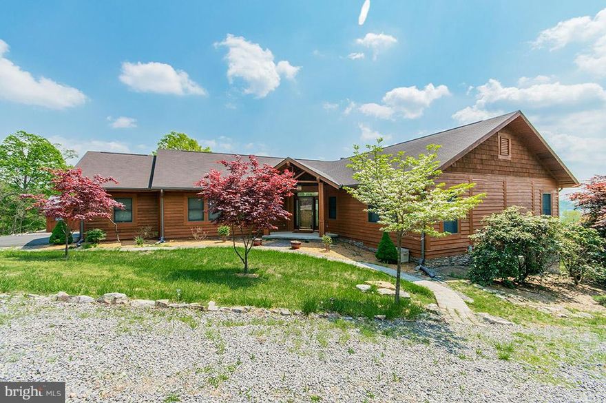 Wonderful views from this custom designed home situated on 2.75 acres close to the Cacapon State Park..  Plenty of space for the family to enjoy as either a full time or retreat home.  Large rear deck to enjoy the easterly views, floor to ceiling stone fireplace in the great room, open floor plan, first floor master bedroom with private bath.  Lower finished level could be in-law suite.