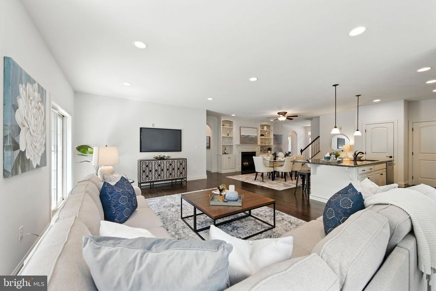 Prepare yourself to be impressed! This home shows like a model and the private lot can not be beat! Totally refreshed with thoughtful upgrades and exquisite details, if you're seeking to move to a 55+ community without sacrificing the features and space of a single-family residence, look no further. The size of this home is generous including areas for family gatherings, guest accommodations, a home office, entertainment and hobbies. Enjoy spectacular views and expansive outdoor spaces designed for relaxation and socializing.

Only an out-of-state move has made this pristine, like-new property available. As you arrive, you'll notice the evident pride of ownership in this meticulously cared-for home. Enter through the gracious foyer, where fresh paint, gleaming hardwood floors, custom window treatments, abundant recessed lighting, and elegant oiled bronze hardware welcome you.

At the heart of the home lies a grand,  modern open area, featuring a spacious kitchen with handsome, creamy cabinetry, exquisite quartz countertops, stainless steel appliances, a generously sized pantry, and an expansive center island, complemented by an inviting dining area, complete with a cozy gas fireplace and custom built-ins. This space seamlessly flows into the expansive Family Room area which expands out to a low-maintenance TimberTech deck with stylish black railings, overlooking serene trees and providing access to the private backyard.

Arched doorways add character as you proceed to the elegant first-floor primary suite. The primary bedroom features a beautiful tray ceiling with uplighting and a ceiling fan, a transom window, and a custom Closets By Design walk-in closet. The primary bathroom is spacious and bright, with an oversized shower, soaking tub, updated vanity and extra cabinetry. Another main floor room, enclosed by glass French doors, serves as a quiet home office or additional bedroom, accompanied by a full guest bathroom. A convenient laundry room and immaculate two-car garage complete the main floor.

Upstairs, you'll find a large open loft area, complete with its own bedroom, full bathroom, and a stupendous custom closet. This level is ideal for a live-in relative, guests, or as a separate area for quiet activities, reading, crafts, or an additional home office.

The lower level is a true showstopper, offering expansive space for entertainment and recreation. Unique wood flooring leads you to a custom wet bar with a sink, wine and beverage fridges, custom cabinetry, and shelving. This area also features another gas fireplace, custom built-ins, and plenty of room to watch the big game or enjoy family time. A separate room can be used as a guest bedroom, hobby room, or additional home office. There is another great full bath and two generously sized storage rooms completing the lower level. Step outside to the charming rear paver patio with a pergola, perfect for savoring the serene backyard views and sounds.

This home was constructed with upgraded landscaping and hardscaping, gutter guards, an enhanced exterior lighting package, sprinkler system, alarm system, and water softener, leaving no detail overlooked.

Located in the desirable Honeycroft Village community, residents enjoy access to a pool area, fitness center, bocce ball, horseshoes, a firepit and community garden. With lawn care, snow removal, and trash services taken care of, you can move in and start enjoying life. Nearby, you'll find restaurants, farmers' markets, golf course and shopping. Schedule your private tour today!