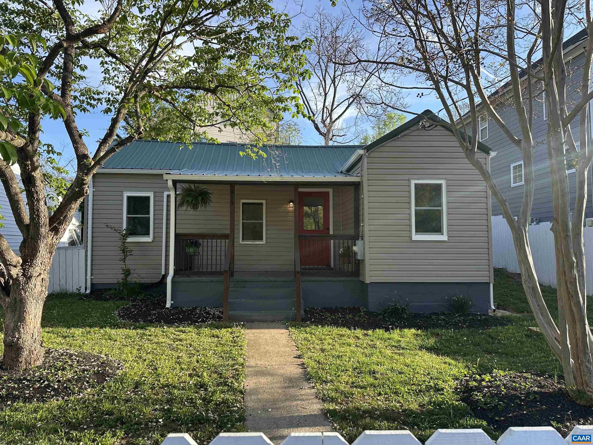 New Price! This darling Belmont cottage packs a punch! You will adore the white picket fence the surrounding the front yard, and the covered porch where you'll enjoy the view of Carter Mountain and watch baseball games right across the street at Quarry Park. The new metal roof adds to the charming exterior style and vintage flair. Inside, the home has been completely renovated and features modern conveniences throughout. New white shaker cabinets are found in the kitchen plus sleek stainless appliances, and a large tiled shower in the bathroom. Ductless HVAC system was added for heating and cooling. There?s even a spacious mudroom off the back with a sliding barn door. At 850 square feet, it's cozy but smartly laid out with 2 bedrooms plus an office. Just 1 mile to the Downtown Mall, minutes to UVA, and around the corner from I64, it's a great location! If you're looking for an affordable, low-maintenance, move-in ready home in a fantastic location, this one's got the charm and the updates to match. Don't miss this opportunity to see this one before its gone!,White Cabinets