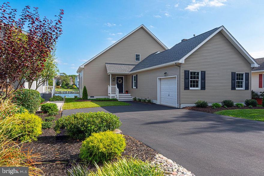 Prime waterfront location with breathtaking views of the St. Martin River, Isle of Wight Bay, and the Ocean City skyline! This is the perfect location, offering not only incredible panoramic vistas but also a protected dock rebuilt in 2023, providing direct access to the bays of Ocean City and the beaches of Assateague Island. Recent updates include a new roof (2023), heat pump with gas backup (2023), granite countertops, new kitchen appliances (2023), blacktop driveway (2023) and new roof decking and rear stairs (2024). A new vapor barrier has been installed in the crawlspace for added peace of mind. This home features a first-floor primary suite, a living room with stunning water views, and a spacious family room with a cozy gas fireplace. The sunroom, along with all bathrooms and the laundry room, showcases luxury vinyl plank flooring, adding both style and durability. Storage is plentiful, with two floored attic spaces, a coat closet, and a pantry. The 15.5' x 19' garage also includes a convenient laundry sink. Enjoy breathtaking sunrises over the bay, glistening waters, passing boats, and even the occasional pod of dolphins. This property offers a serene and picturesque waterfront lifestyle in an unbeatable location!