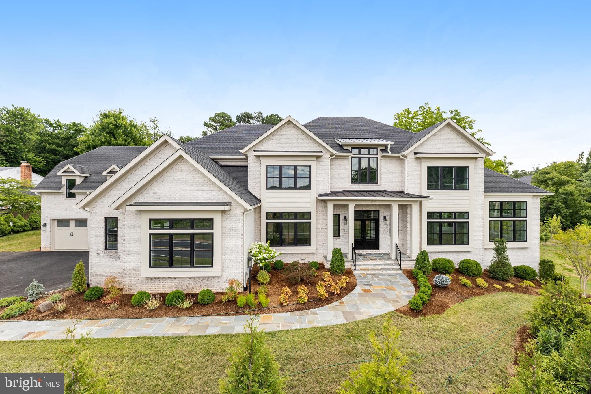 This EXPANDED Winthrop model features designer finishes and exceptional details consisting of 4-sides brick, oversized black windows and a 4 car garage. A newly designed "clean contemporary" elevation and dramatic custom iron front entry door give this home unparalleled street presence. Expansive kitchen with stacked designer inset cabinetry opens to the sunroom and family room featuring a 60" horizontal fireplace. Additional rooms include formal living room, dining room, library and conservatory boasting cathedral ceilings. The upper level provides 5 ensuite bedrooms including the spectacular owner's suite with separate sitting area, 2 huge walk-in closets. The spa-like bathroom includes oversized frameless shower, free -standing soaking tub dual vanities and separate water closet. A walkout lower level provides a theater/ media room, wet bar, casual living room, mirrored exercise room, and bedroom with dual entry full bath. Additional features include 10ft ceilings on the main level with 9ft ceilings on the upper and lower levels, solid core doors throughout the home and expansive deck. Available for Immediate delivery.