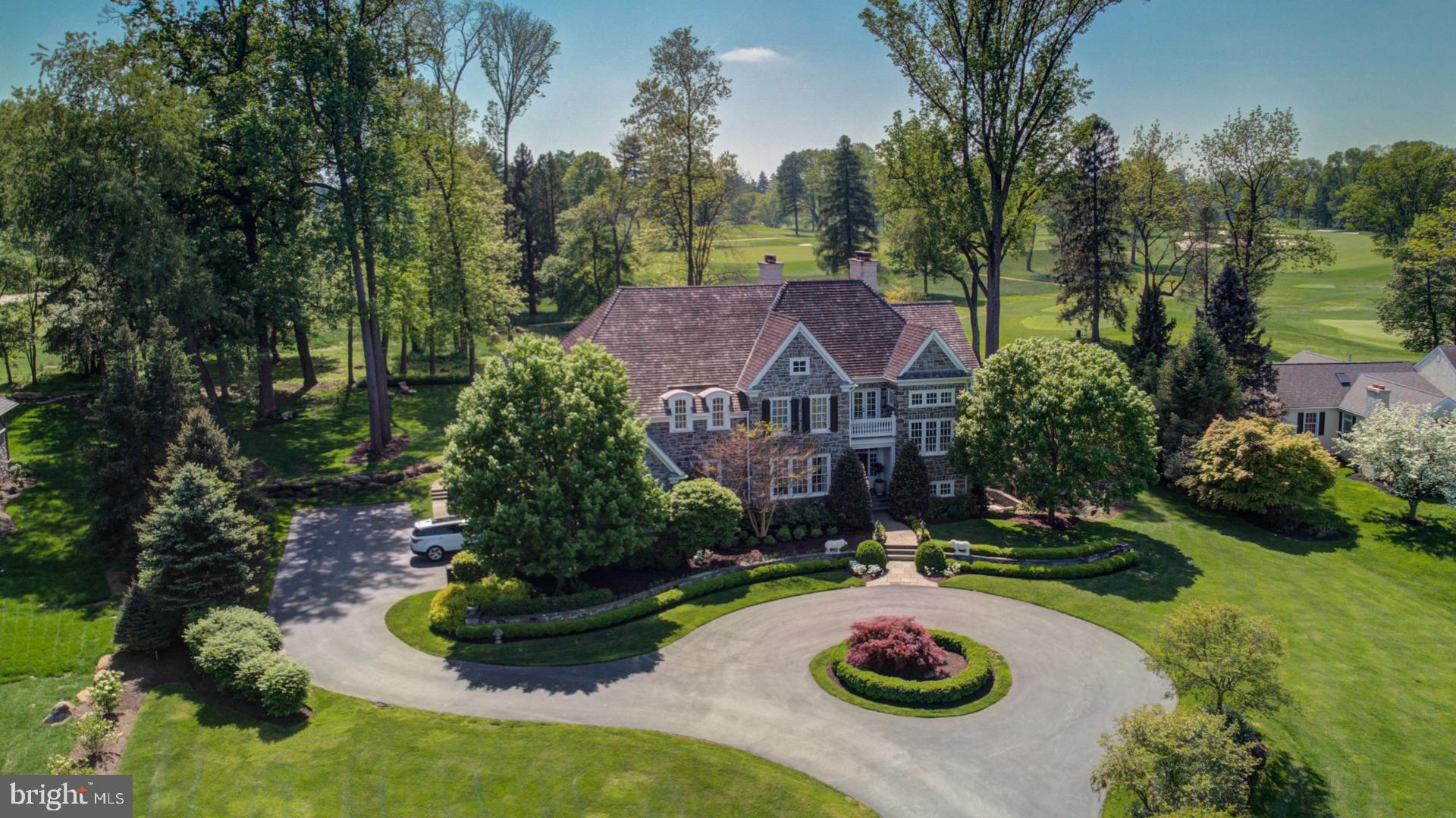 Have you always dreamed of living on a golf course?? Well dream no longer as this absolutely stunning home and property graciously adjoins one of the most prestigious golf courses in the country....ARONIMINK!! This magnificent stone colonial was masterfully created by Dreuding Builders and exudes a sense of sophisticated elegance as it gracefully sits high on a hill on a quiet cul-de-sac street. An inviting circular driveway with extensive landscaping leads one to be in awe of its grander while providing a warm and"Welcome Home" feeling. A flagstone walkway beckons you inside into this over 9,000 sq ft expanded Springhouse Model Home where natural sunlight gently beams across gleaming Brazilian Cherry floors carrying you from room to room. The open floor plan provides a continues and natural flow from the formal rooms of the house into the soul of the everyday living family friendly spaces. Loaded with many upgrades and glorious mill-work this magnificent home is in a class of its own and could not be replicated today at its list price. Every room of the First Floor captures the golf course views with extensive french doors leading to a warp around flagstone terrace with built-in gas grill. The exquisite First Floor has an expansive Foyer with magnificent staircase, formal Living and Dining Rooms, a handsome Office with floor to ceiling mahogany wainscoting and built-in cabinetry, formal and informal Powder Rooms, a Family Room with coffered ceiling opening into a recently renovated gourmet Kitchen, stunning Breakfast Room, Wet Bar, Potting Room and Mudroom leading to a 3 car attached Garage. A grand staircase leads you to the Second Floor where there is a sitting area outside the luxurious Master Suite with soaring ceilings and gas fireplace, His and Her luxurious Baths, and a Juliet balcony that captures Aronimink's beautiful golf course. Gleaming Brazilian Cherry hardwood floors carry you throughout the Second Floor where there are 4 additional en-suite Bedrooms, and impressive Laundry Room. Backstairs lead to the Third Floor private hideaway with expansive closets, storage and Bath. The entertaining spaces continue into the fully finished Lower Level that opens to a magnificent outside fireplace and sitting area gently nestled into the side of a hill. The Lower Level is completed with a gorgeous mahogany Bar, Wine Storage and Billiard spaces, Exercise Room, Full Bath, Craft and Storage Rooms. This property is truly one of a kind sitting on over 1.3 glorious acres that adjoins a magnificent golf course with sunset views to die for. It is special in every sense of the word and has been beautifully updated and maintained while providing access to all major highways, shops and restaurants in both Newtown Square and Wayne. Don't miss your chance to own this spectacular property and home on a private oasis with glorious storybook setting!!