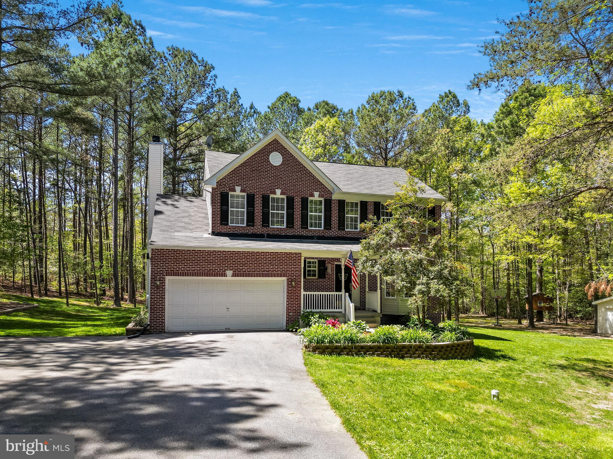 Welcome to your own slice of paradise on a sprawling two-acre flat lot, where modern elegance meets colonial charm. This incredible home boasts four bedrooms, 3.5 bathrooms, an attached garage, and a finished basement with the potential for a fifth bedroom, designed to exceed all expectations. Step inside and be greeted by the warmth of luxury vinyl plank flooring that flows seamlessly throughout the main level. The heart of the home is the kitchen, featuring a large island adorned with quartz countertops and sleek stainless steel appliances. The adjacent living area offers a cozy fireplace on chilly evenings or step outside onto the expansive trex deck perfect for enjoying the private backyard, meals outside, and entertaining. Retreat to the primary suite, where high ceilings create an airy ambiance, complementing the luxurious ensuite bathroom. Key features in the primary bathroom include the large soaking tub, separate shower, and double sinks. A large walk-in closet provides ample storage for your wardrobe. Three additional bedrooms provide plenty of space for family members or guests, each appointed with ample closet space. The finished basement offers additional living space, complete with a mini bar area for entertaining guests or unwinding after a long day. With the potential for a fifth bedroom, a home office, or a media room, this versatile space adapts to your lifestyle with ease. The basement also offers a full bathroom, laundry room, and storage space. Plus, with the addition of a boiler system, you can enjoy energy and cost efficient heating throughout the home, ensuring comfort during the colder months. Outside, a large shed provides storage for outdoor equipment, while the expansive backyard offers endless possibilities for recreation and relaxation. Whether you're gardening, playing sports, or simply enjoying the peace and quiet, this backyard is perfect for it all. Incredible location with easy access to top-rated schools, shopping, and dining, this colonial home offers the perfect blend of privacy and convenience. Approximately 26 miles to NAS Patuxent River, 40 miles to Joint Base Andrews, 50 miles to Joint Base Anacostia Bolling/DC.