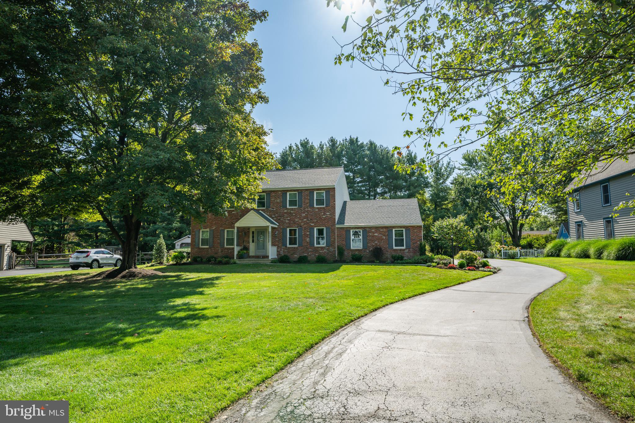Just minutes from the heart of Doylestown Borough, discover the highly sought-after community of Old Mill Estates. With only 68 distinctive homes, this cul-de-sac neighborhood is known for privacy, charm, and convenience. Welcome to 16 John Dyer Way, a classic Colonial that blends timeless details with modern comfort. Step inside the center hall and choose between a sunlit sitting room or an elegant formal dining room, both enhanced with crown molding and chair rail accents. The heart of the home is the spacious kitchen and breakfast room, featuring maple and glass cabinetry, granite counters, a second prep sink, and a bay window that fills the space with natural light. Just steps away, the family room invites relaxation with its brick wood-burning fireplace, raised hearth, and direct access to the expanded Trex deck—perfect for entertaining and overlooking a private backyard with mature pines, perennial gardens, and storage shed for all your lawn and garden tools. The first floor also offers a convenient mudroom entry, laundry area, and powder room. Upstairs, find four generous bedrooms, including a primary suite with walk-in closet, skylit ensuite bath, soaking tub, and stall shower. Three additional bedrooms share an updated full hall bath. The partially finished basement expands your living potential with space for recreation, storage, and utility systems which include both water treatment and softening systems for the home's private well. An extra large two-car garage with inside access completes the picture. With public sewer, a prime location, and a home ready for your personal touches, 16 John Dyer Way offers the perfect balance of character, space, and value. Come see why Old Mill Estates is one of Doylestown’s most desirable neighborhoods—schedule your private tour today!