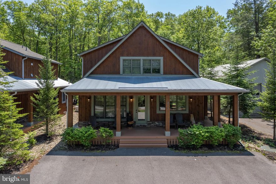 Escape to Sage Mountain Retreat, a beautifully crafted 5-bedroom, 4-bath custom home located on a quiet road and nestled in a private wooded setting-just minutes from Deep Creek Lake State Park and walking distance to some of Deep Creek’s most popular lakefront restaurants and Silvertree Marina partial lakeviews from front deck. This fully furnished retreat features: Modern kitchen with granite countertops, Two spacious living areas for relaxing or entertaining, 2 Primary Bedroom suites on second level with tiled showers and double vanities, Additional en-suite bedroom on main level and 2 additional bedrooms and a full bathroom on the lower level.  A large hot tub on the back deck and fire pit area for outdoor enjoyment.  A huge, 30' x 55' insulated shop building houses a private, indoor PICKLEBALL COURT and offers garage parking for up to 4 cars and storage for all your lake toys/boat - a true bonus at this property. Currently an established Signature Collection Property vacation rental, Sage Mountain Retreat offers both luxury and income potential in one of Deep Creek's most desirable and convenient areas. House is also equipped with a Back-up generator – a huge comfort when you’re away during stormy winter nights. Schedule your tour today and experience this exceptional mountain getaway.