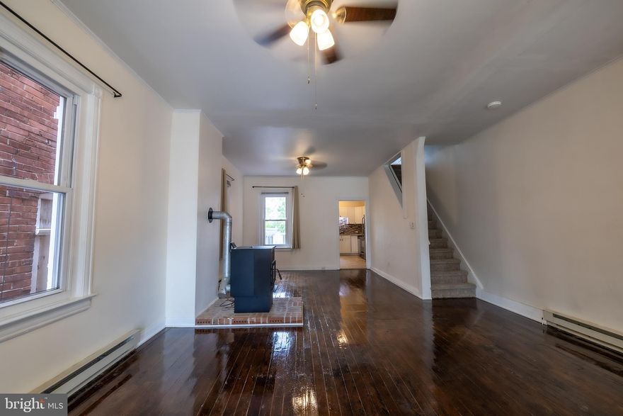 Charming townhome blending classic character with thoughtful updates throughout. The bright front sunroom welcomes you into a spacious main level featuring gleaming hardwood floors, high ceilings, and an open living and dining area. Updated kitchen offers stainless steel appliances, tile flooring, stylish backsplash, and ample cabinet space. Convenient main-level laundry and half bath add everyday functionality.

Upstairs features generously sized bedrooms with abundant natural light, new carpeting, and a renovated full bath with modern tile surround. An additional upper-level room provides flexibility for a home office, nursery, or guest space. Outdoor amenities include a rear deck, fenced backyard, and patio area ideal for relaxing or entertaining.

Move-in ready with a blend of historic charm and modern conveniences, this home offers comfortable living both inside and out.