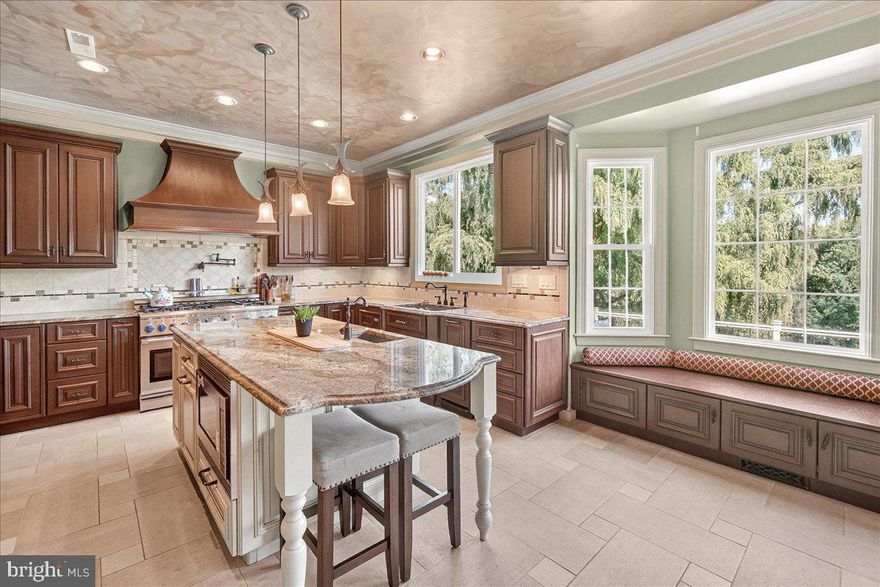 Welcome to this magnificent home in the highly sought-after Spring Ridge community, offering over 6,000 square feet of sophisticated living space. With five total bedrooms and four and a half baths, this home provides ample space for comfortable living and entertaining.

As you step inside, you are greeted by a grand foyer that sets the stage for the elegance found throughout. The main level features a formal dining room, an office, and a versatile living room/den. The open-concept family room is the heart of the home, centered around a cozy stone fireplace. The gourmet kitchen is a chef's dream, featuring a large island, stainless steel appliances, butler pantry and a dedicated eat-in area. A convenient powder room with water closet completes the main level.

Upstairs, the expansive primary suite is a true retreat, boasting a separate sitting room, a luxurious ensuite bathroom, and a custom closet. This level also includes three additional bedrooms and a beautifully updated laundry room conveniently located just outside the primary suite. The second bedroom has its own ensuite bathroom, while the third and fourth bedrooms share a Jack and Jill bathroom.

The finished lower level is designed for both recreation and comfort. It features a fantastic in-law suite with its own bedroom, full bathroom, and kitchen. This level also includes a dedicated bar room with fireplace, a spacious entertainment/living area, and plenty of storage.

Step outside to discover your private oasis. The backyard is fully fenced and features a stunning two-tier Trex deck that overlooks a beautifully maintained garden. Below the deck, you'll find a covered patio, and another separate patio area with a pavilion—both equipped with electricity for all your outdoor needs. A charming patio in the front of the house on each side of the entrance and a two-car garage complete this exceptional property.

This property is part of the desirable Spring Ridge community, which offers a wealth of amenities including a pool house, several pools, a splash zone, parks, tot lots, shopping, restaurants, childcare centers, walking trails, a school, doctor's offices, and more!  Enjoy peace of mind with a 1-year home warranty and 1 year of HOA dues paid by the seller!!!