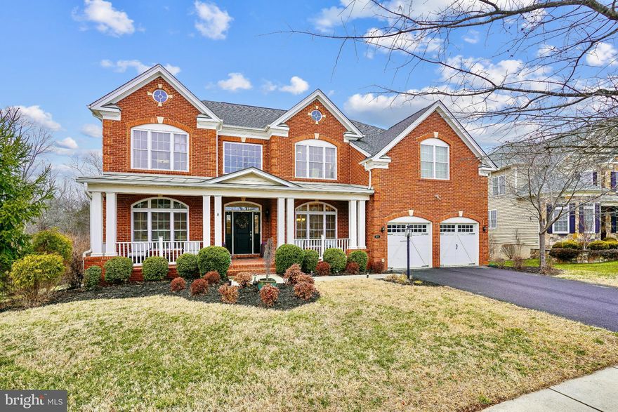 Nestled within the prestigious Dominion Valley Country Club, this exquisite Duke Model, Colonial-style, home offers a harmonious blend of luxury and comfort, perfect for those seeking an elevated lifestyle. Built in 2017, this home boasts almost 6500 finished square feet of meticulously designed living space, showcasing high-end finishes and thoughtful details throughout. Step inside to discover an inviting open floor plan that seamlessly connects the gourmet Palladian Kitchen, complete with stainless steel appliances, an expansive island with a prep sink, and upgraded level 5 countertops, to the two story family room, where a cozy gas fireplace creates a warm ambiance. The kitchen also features a breakfast area and a pantry, making it a culinary enthusiast's dream. Elegant crown moldings, chair railings, and recessed lighting enhance the sophisticated atmosphere, while large windows and skylights flood the space with natural light. The main level includes a versatile entry-level bedroom and bathroom as well as an office with french doors and a formal dining room, perfect for hosting gatherings. Retreat to the luxurious primary suite, which features a spa-like bathroom with a soaking tub, walk-in shower, and dual vanities, along with 2 spacious walk-in closets with custom shelving. The large open basement offers endless possibilities, with a huge recreation room, game room, hobby room, full bath, unfinished workshop and a walkout level that leads to the beautiful yard, which backs to serene trees, providing a tranquil escape. Enjoy outdoor living on the expansive deck and patio, perfect for entertaining or simply unwinding in nature. The exterior of the home is equally impressive, featuring extensive hardscaping, exterior lighting, and a well-maintained yard. The property includes an attached two-car garage with a front entry and driveway parking, ensuring convenience and accessibility. As part of the Dominion Valley community, residents enjoy a wealth of amenities, including a golf course, fitness center, swimming pools, tennis courts, and walking trails, all within a secure, gated environment. The community's commitment to maintenance and security allows for a carefree lifestyle, where leisure and recreation are just steps away. This remarkable home is not just a residence; it's a lifestyle choice that embodies luxury, comfort, and community. Experience the perfect blend of elegance and warmth in this stunning property, where every detail has been thoughtfully curated for your enjoyment. Welcome Home.