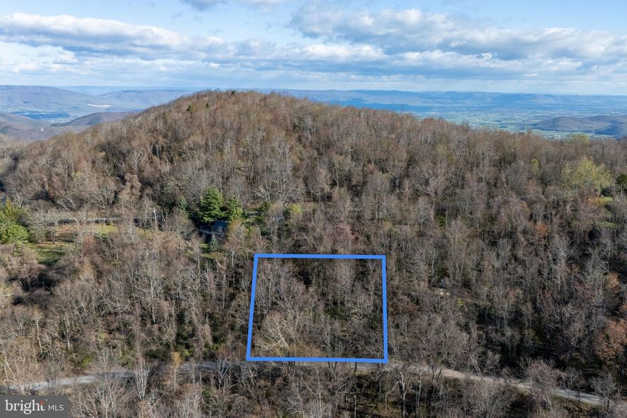 Welcome to Skyline Lakes where the air is cooler and nature abounds! If you are dreaming of building a secluded cabin or short term rental near the Shenandoah National Park, look no further as you have found the perfect lot. This wooded lot has a new survey and a two bedroom septic letter issued in 2025 allowing for various future development opportunities. Access is off a gravel road maintained by the HOA. Nearby amenities include Big Meadows in the Shenandoah National Park, the Hawksbill pool (seasonal), a community lake, Massanutten Resort, and the charming town of Luray, Virginia! Reach out today to make this property your own.