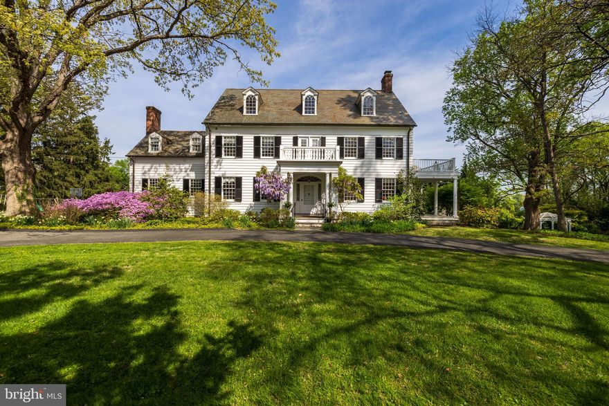 Built in 1908, this Colonial Revival home was originally built and occupied by the Ridgely family. Seamlessly expanded with a stunning Kitchen/Family Room addition, perfect for today's modern living. Clad in painted cedar siding with a slate roof and copper gutters/downspouts. A center hall with curved staircase and beautiful architectural details welcomes guests from the classically detailed front porch. The Living Room with fireplace, formal Dining Room and cozy Den with built-in bookcases are all accessed from the Center Hall. The Kitchen features white raised-panel custom cabinetry, granite counters and backsplashes, butler's pantry area and open flow to the vaulted octagonal Breakfast Room and Family Room beyond. The sunken Family Room with fireplace and custom built-ins, along with the Breakfast Room has architectural features borrowed from Hampton Mansion. A sumptuous, totally custom fitted Primary Suite anchors the 2nd level with a serene blue and white Bedroom with fireplace and built-in cabinetry. The Primary Bath features a central free-standing glass-enclosed shower stall, custom crafted vanities, jetted spa tub and custom closets, walk-in closet and cabinets. Set amidst beautifully landscaped gardens and grounds on 1.66 acres.