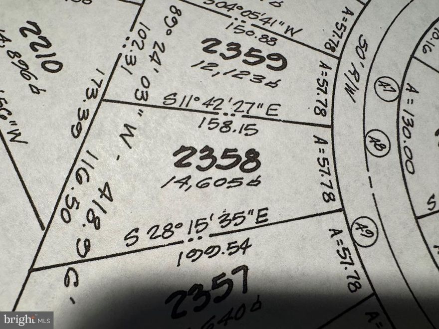 Wooded lot in Captain's Cove. PRICED BELOW ASSESSMENT VALUE. Includes access to three pools, golf course, playground, dock, boat ramp, boat slips, restaurant, fitness center, and more.