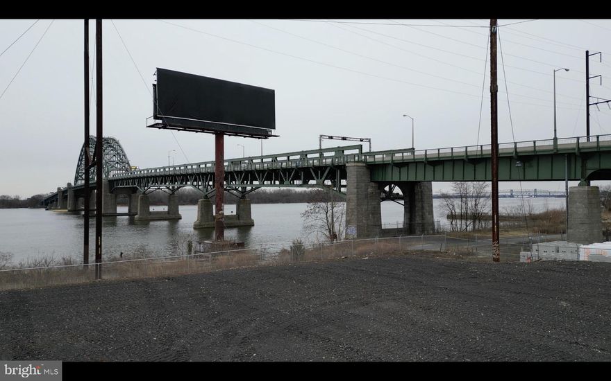Expansive 3.1-acre industrial/commercial lot available for lease, featuring Delaware River frontage and an unbeatable location at the foot of the Tacony-Palmyra Bridge. This property offers exceptional connectivity and visibility, making it ideal for businesses seeking a strategic site in Northeast Philadelphia with direct access to New Jersey and major transportation routes. Zoned ICMX (Industrial Commercial Mixed-Use), the site provides maximum flexibility for a wide range of uses. With negotiable lease terms, you can tailor the arrangement to fit your specific needs and vision. All interested parties are encouraged to conduct due diligence as some items in the listing might not be 100% accurate. This price reflects monthly rent.