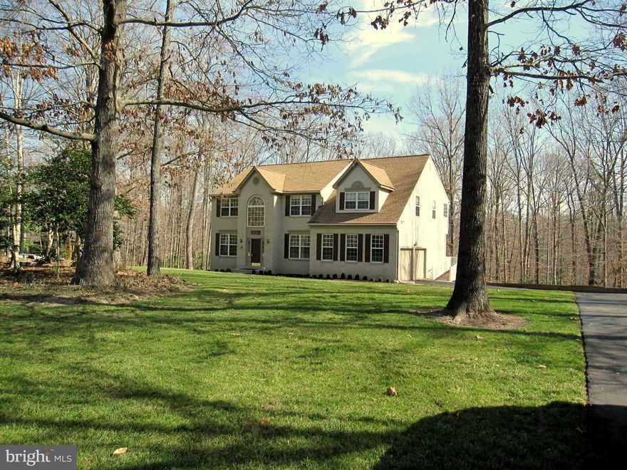 Lovely Colonial in quiet neighborhood flowing floor plan with hardwood floors bright living room separate dining room  spacious eat-in kitchen 4 bedrooms upper level w/attached den or nursery off the master 3 full baths gas fireplace heatpump w/propane backup recently replaced roof large deck over 2 acre lot backs to trees for your privacy great location