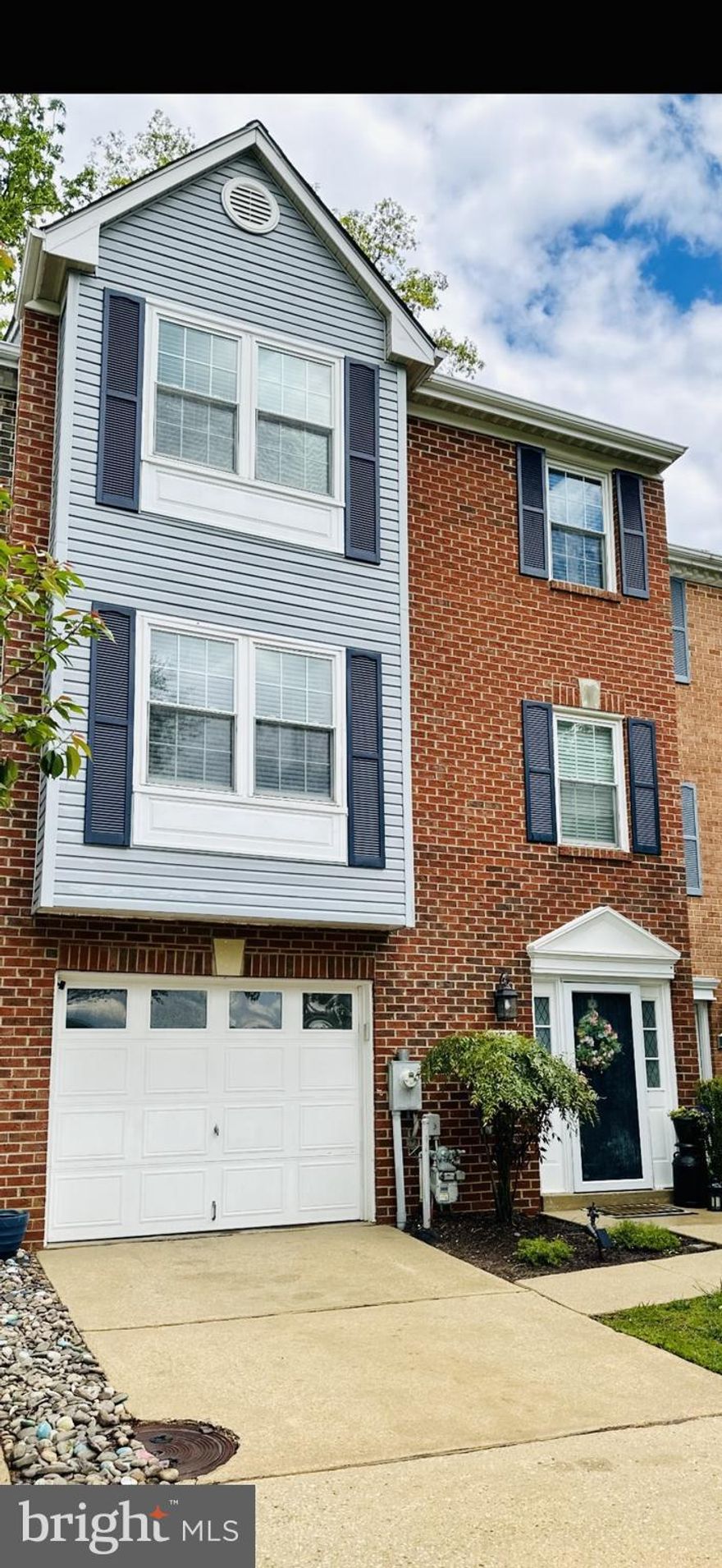 This townhome has it all!  Located in the desirable area of Bay Hills, amenities galore!  Walk to shopping, dining and other essentials without ever leaving the community!  This home fronts to Bay Hills Golf Course holes 3 and 4.  From the rear of home enjoy the wooded privacy and winter water views of Deep Creek.   Just steps away to the community pier and canoeing/kayaking.  The interior of this home affords three levels with a bath on each.  Entry level at grade can be accessed from the garage and includes a powder room and family room/4TH bedroom with gas fireplace and sliders to rear access and your own private sanctuary with patio area and hot tub!  The main living level boasts a spacious living room with an abundance of natural light.  The kitchen has been updated and includes plenty of cabinet storage and area to entertain.  Adjoining dining area leads to second story deck and fabulous views of wooded area and creek.  The upper level includes three bedrooms.  The primary bedroom with cathedral ceiling and luxury bath with soaking tub and separate shower.  Two additional bedrooms share use of the main upper level full bath.  This  wonderful home has it all from views, amenities, an award winning school district and comforts abound!