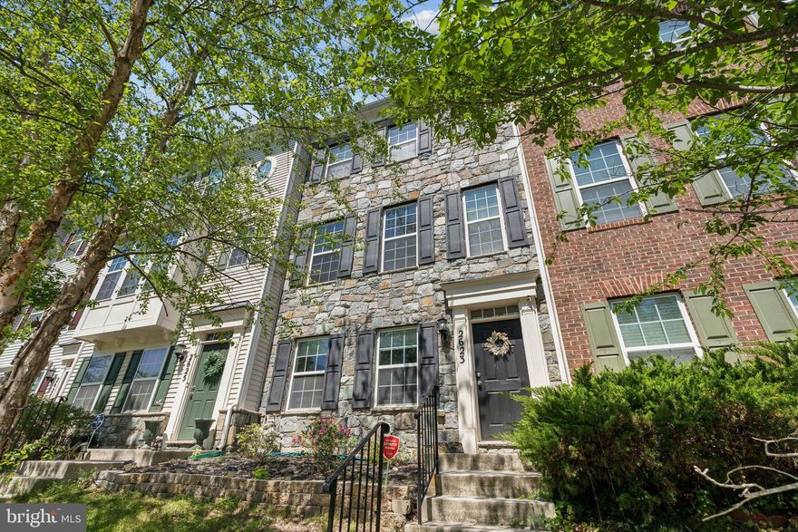 *21K Price Improvement!!* This move-in ready, stone-front three-level home offers space, functionality, and a prime location. Enter through the two-car rear garage into the first level, which includes a flexible second living area that can function as a rec room, office, or guest space.

Upstairs on the main level, you'll find a bright, open-concept layout featuring recessed lighting and an electric fireplace. The kitchen is equipped with granite countertops, stainless steel appliances, a gas cooktop and range, pantry storage, and well-maintained cabinetry. Just off the kitchen is a large, low-maintenance composite deck — perfect for grilling, entertaining, or unwinding outdoors.

The top floor includes the primary bedroom with vaulted ceilings, a walk-in closet, and an en-suite bath with a separate tub and shower. Two additional bedrooms share a full hall bath, and the washer and dryer are conveniently located on this level as well.