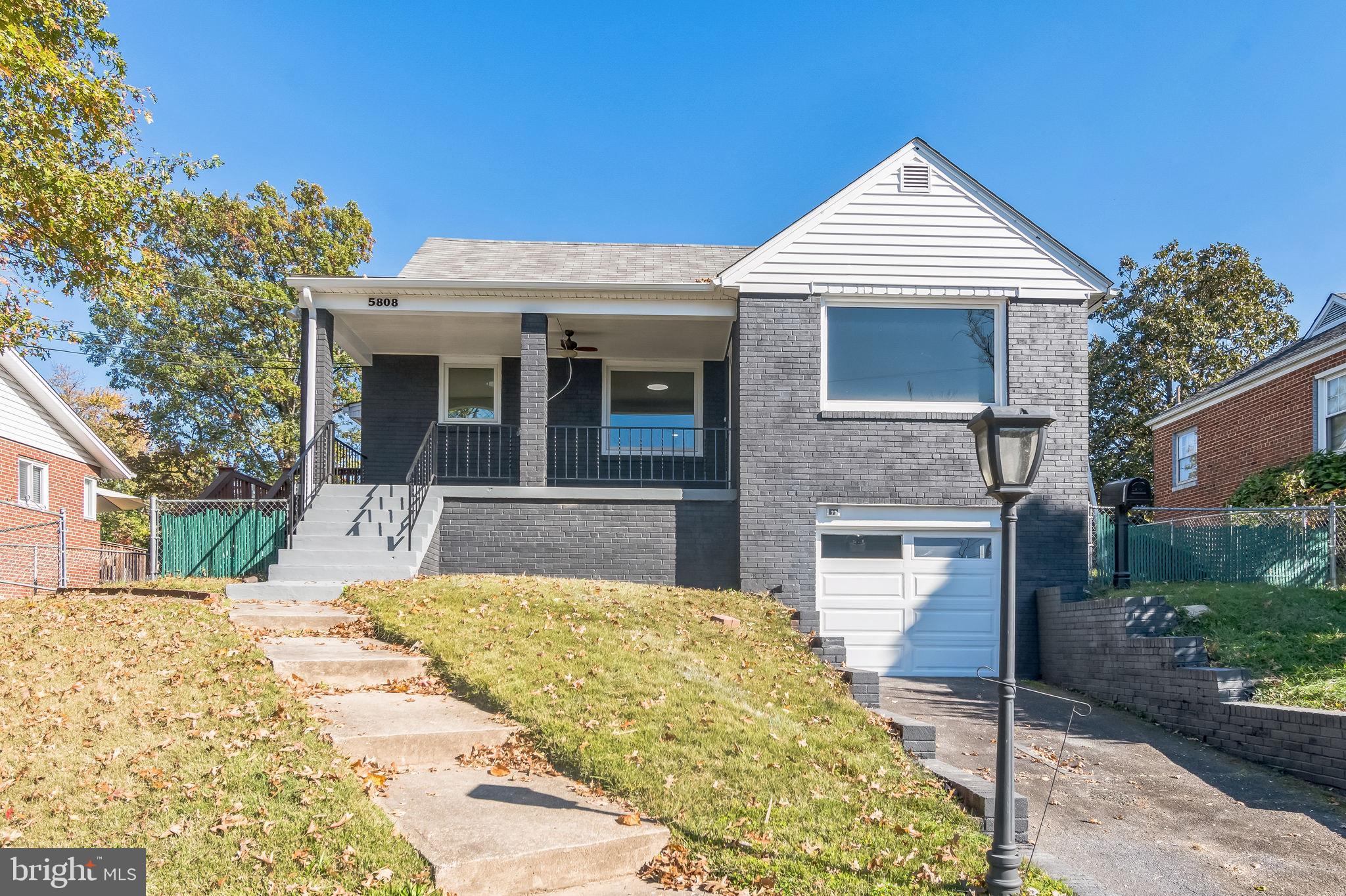 This charming 3-bedroom, 2.5-bathroom Cape Cod home in Forest Heights offers a delightful blend of character and modern convenience. Set on an elevated lot, this brick home features a welcoming front porch, the perfect spot to relax and watch the sunset over the Potomac River. Inside, the main floor offers two spacious bedrooms along with a full bathroom and a half bath, making it ideal for you and your guests. The upper level features an additional private bedroom. The home is equipped with an electric heat pump for year-round comfort and is paired with a gas water heater. The upgraded kitchen has a gas range with gray cabinetry, quartz countertops, and stainless steel appliances, ensuring efficient functionality. Hardwood floors flow through much of the home, complemented by beautiful wood doors and trim, adding timeless character. The living room boasts a gorgeous fireplace for a cozy gathering space. The fully finished basement expands the living area, featuring a full bathroom and a paneled recreation room with a built-in bar, ideal for entertaining or additional guest space. The attached one-car garage includes a separate storage room, providing ample space for tools and seasonal items. This well-maintained home is conveniently located near the National Harbor and Nationals Stadium, providing easy access to entertainment, dining, and outdoor activities. With its blend of classic charm, thoughtful updates, and scenic views, this Cape Cod delivers a harmonious balance of convenience and a laidback lifestyle.