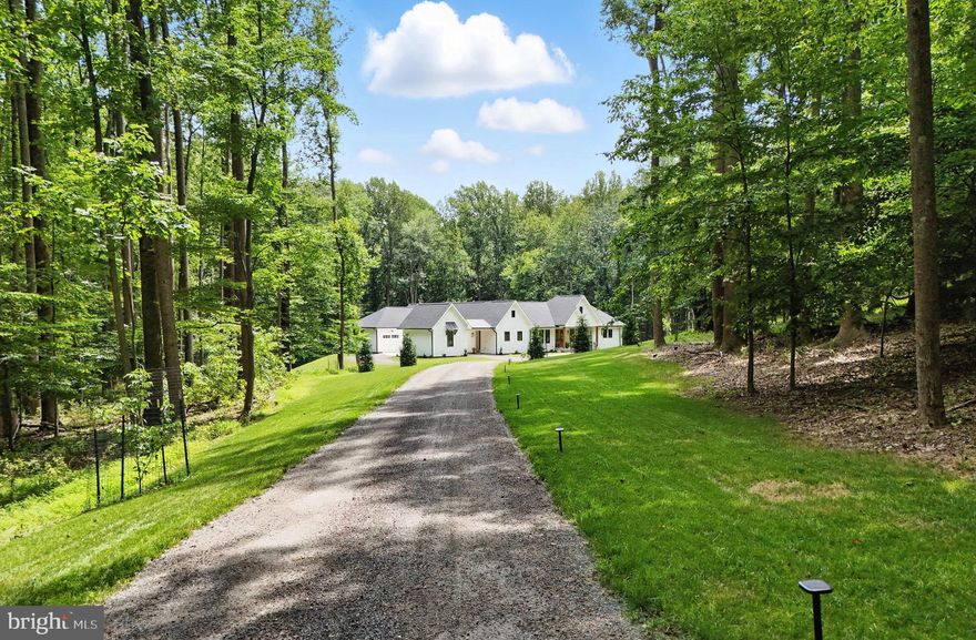 Experience the pinnacle of luxury & craftsmanship in this one-of-a-kind modern farmhouse with MAIN LEVEL LIVING, custom built in 2023 with uncompromising quality & thoughtful design throughout. Perfectly sited on 31 private, wooded acres in the prestigious conservancy community of Catoctin Springs, just seven scenic miles from downtown Leesburg. This estate offers an unparalleled blend of serenity, sophistication, & innovation. Every detail has been curated for those who demand the extraordinary!

Constructed by award-winning Horizon Contracting (Best of Loudoun 2022 & 2023), this  exceptional home is a masterclass in architectural excellence, where no expense was spared. From the first glance, you'll be captivated by the stately curb appeal offering HardiePlank siding, black-trim Marvin windows, a 30-year architectural roof, & an inviting covered front porch with tongue-and-groove ceiling & rich wood columns, framed by an elegant paver walkway, lush landscaping & mature trees.

Enter through grand double wood doors into an open-concept interior with beautiful 7.5” wide plank white oak flooring, & custom wood beams creating a feeling of warmth & sophistication. A dramatic 50” Castle brick wood-burning fireplace anchors the family room, flowing seamlessly into a stunning chef’s kitchen! Outfitted with Signature Cabinetry in white & sand finishes, a 36” Wolf gas range with pot filler and custom hood, Sub-Zero refrigeration, oversized island, Zellige tile backsplash, & an oversized shock assisted pass-through window, the kitchen is designed for effortless indoor-outdoor entertaining. A walk-in pantry & separate laundry room are located off the kitchen & dining area for added convenience.

Retreat to a luxurious primary suite where expansive windows frame postcard-perfect views! Tray ceilings with exposed beams and a shiplap finish lead to private access to the screened porch. The spa-inspired bath features radiant heated floors, Silestone double vanities, a dual-head shower, oversized soaking tub, and a truly spectacular lit custom closet worthy of its own spotlight

Three additional main-level bedrooms offer flexibility, one with a private ensuite bath, & two sharing a beautifully appointed dual-vanity bath with upscale finishes. A designer powder room adds sophistication for guests.

The media/game room features white oak paneling, a sleek linear gas fireplace, & expansive sliding doors that open to outdoor living. Whether it’s movie night or game day, this space delivers comfort & style!

Designed for year-round enjoyment, this home offers an effortless transition from indoors to out with expansive sliding glass doors that open to a 780 sq ft screened porch. This stunning outdoor living space is thoughtfully appointed with tongue and groove ceilings, built-in heaters, motorized screens, and an inviting wood-burning fireplace creating a comfortable retreat in any season.

The unfinished walkout lower level with 9-foot ceilings, double-door entry, & rough-ins for a full bath & wet bar offers more than 3,700 sq ft to expand as you wish, ideal for a gym, wine cellar, & guest suite.

A covered breezeway leads to a finished one car garage w/ 11' ceilings and half bath, the perfect 'man cave' is ideal for a workshop or studio,  with an additional 2-car attached garage, all seamlessly integrated for impressive curb appeal and effortless guest arrival.  

Beyond the beauty, this home is engineered for performance & comfort with energy-efficient dual-zone HVAC, a hybrid hot water heater, and Verizon FIOS for seamless connectivity!

Nestled in one of Loudoun County’s most exclusive communities, this property is just moments from award-winning wineries, farm-to-table markets, hiking trails, & key commuter routes. Whether you're headed to Dulles Airport, Tysons, or historic downtown Leesburg, this rare opportunity offers privacy, modern luxury, & a lifestyle that’s second to none!