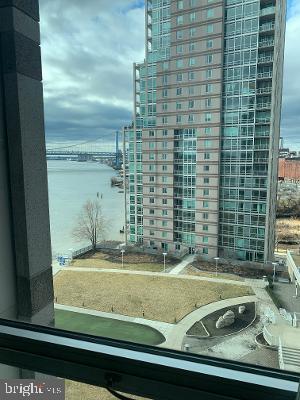 South facing, sun drenched unit with walls of windows at Waterfront Square. Large one bedroom with a den that can be used as an office or bedroom, one car parking included. This is a beautiful 1 bed/1 bath den unit with 1 car parking located in the Regatta building at Waterfront Square! This unit features great views of the Ben Franklin Bridge and river as well as a nice view of the landscaped common area - Custom kitchen with granite counters, tile backsplash and stainless steel appliances & an open living room with hardwood floors. Bedroom has hardwood floors & walk-in closet. Den with wall to wall carpeting. Bathroom has a jacuzzi tub and maple & granite vanity - Condo fees include a 24-hr concierge, an indoor pool, shuttle service, fitness center and a beautifully landscaped courtyard. This building is located in a gated community with an onsite spa and 24 hour service staff. Building is pet friendly. Regatta Building, closest to the pool. Storage unit available for sale on the same floor.