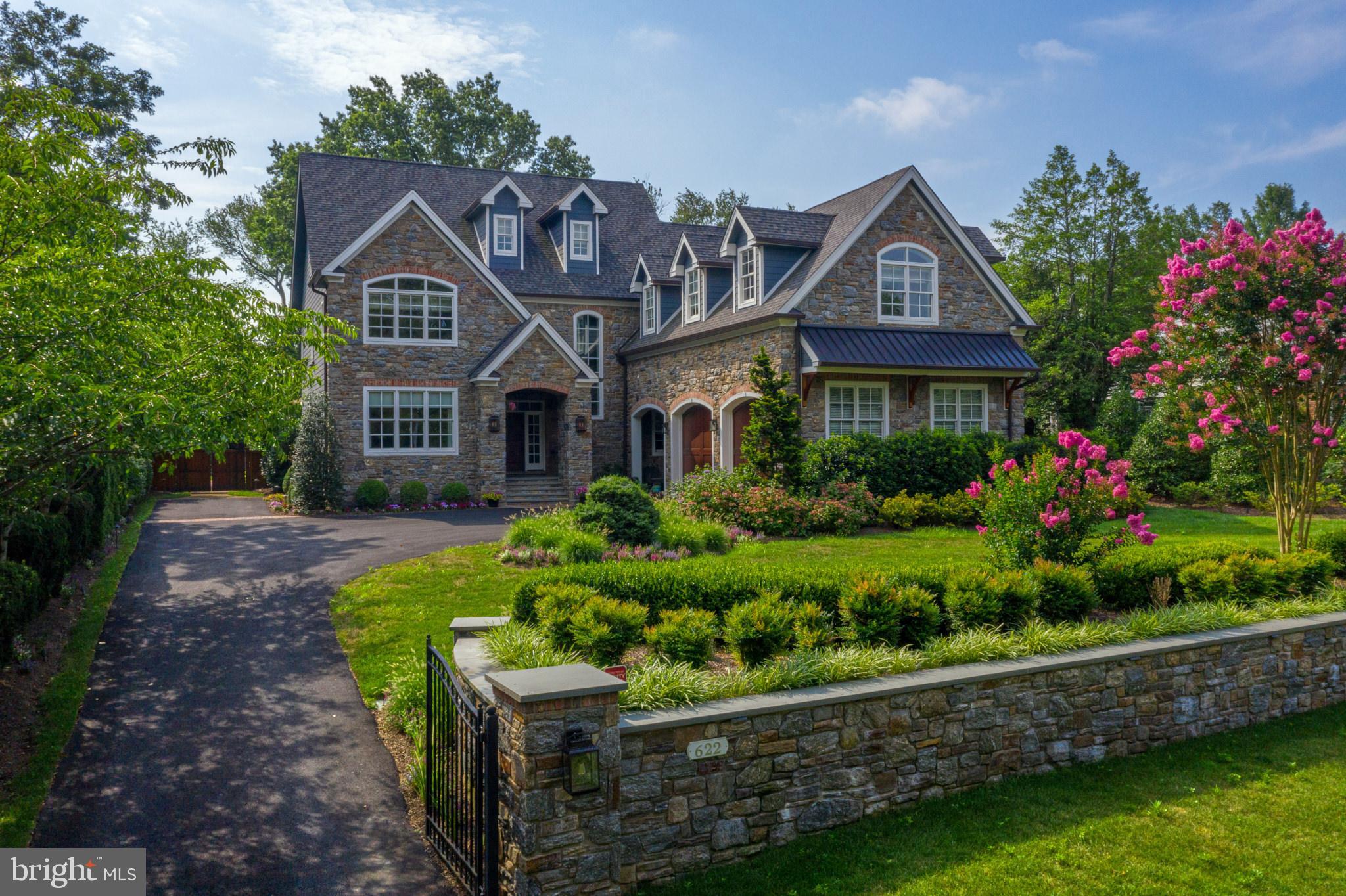 Featured as the acclaimed "Philadelphia Magazine Design Home" in 2014, this stunning and unique property continues to turn heads on its quiet, upscale street in desirable Wyndmoor. Set upon a private, tree-lined half-acre homesite, 622 E. Gravers Lane is just a short stroll or bike ride away from the quaint shops and restaurants lining "The Avenue" in Chestnut Hill. This spectacular home was thoughtfully designed to appeal to today's modern lifestyle, and showcases an open layout with fantastic flow and large, sophisticated-yet-informal gathering spaces, which make it comfortable for everyday living and well-suited for entertaining! Upon entry, guests are welcomed into a dramatic two-story Foyer highlighted by a sweeping staircase that accentuates the high ceilings. Elegant hardwood flooring extends throughout the entire Main Level of the home, creating a seamless transition between spaces. A cozy Living Room is situated off of the Foyer and features built-ins and large windows that bring in an abundance of natural light. But, the true heart of this home is the show-stopping gourmet Kitchen; built to impress even the most discerning Culinarians! Complete with dual 36" SubZero refrigerators flanking a 48" Wolf gas range, custom cabinetry accented by quartzite natural stone countertops, Cararra marble backsplash tile and a large pantry adjacent to the private catering kitchen, this space will delight those who enjoy quiet meals with the Family or have a flair for entertaining! Across from the Kitchen, the spacious Dining Room can accommodate a large table with plenty of seating and is accented by two bars and built-in refrigerated wine storage. An arched entryway from the Kitchen and Dining areas opens into an elegant Great Room boasting cathedral ceilings, a floor-to-ceiling gas fireplace, and a window wall with accordion doors opening onto the expansive flagstone patio and outdoor living spaces.. A private Study, three powder rooms and a Mudroom providing covered access to the semi-detached garage completes the Main Level. Upstairs, the Master Suite offers an incredible private sanctuary in which to relax, unwind, and recharge. Equipped with a wet bar with beverage cooler, motorized window shades, elegant vaulted ceilings, massive "his" and "her" dressing rooms, and a Master Bath one must truly see to believe, this soothing space provides the perfect retreat after a long day. A spacious bedroom-level laundry room and three additional bedrooms, one with private en-suite bath and the other two with shared access to a Jack-and-Jill bath complete the second floor. The third floor features a large finished loft space with private bath and walk-in closet; perfect for doing homework, or lounging with friends while watching a movie! Not to be outdone by the other three levels of the home, the finished Lower Level is beautifully appointed with a spacious living area and wet bar, fitness room with mirrored wall, powder room and changing room adjacent to large sliding glass doors providing access to the outdoor pool and patio areas, and a private guest suite featuring a bedroom with access to full bath and separate laundry room. A spectacular outdoor oasis awaits, featuring a beautiful heated pool, private fenced-in yard outfitted with low-maintenance turf, decorative landscape lighting, outdoor living room with wood-burning fireplace, and a covered kitchen / bar area with built-in TV and heat lamps for those chilly Fall "game days". A private elevator, whole-house generator, over-sized two-bay garage with lift for 3rd car and array of automated "smart home" features throughout the home add to the modern conveniences and worry-free lifestyle enjoyed by its residents. With convenient access to Philadelphia and all major area commuting routes, this property offers unique and unparalleled luxury in the perfect location!