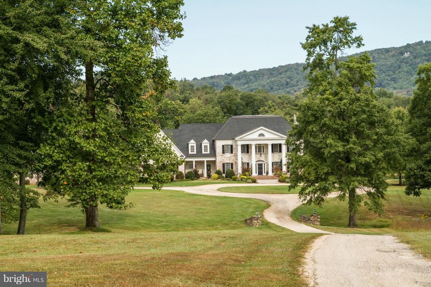 REDUCED - Extraordinary brick colonial on 50+ gorgeous acres in prestigious Greystone. Over 9000 sq.ft.of spectacular living space featuring 3 beautifully finished levels. Heated pool, tennis court and brilliant gardens overlook a picturesque pond with fabulous mtn views,in a private & secluded location.