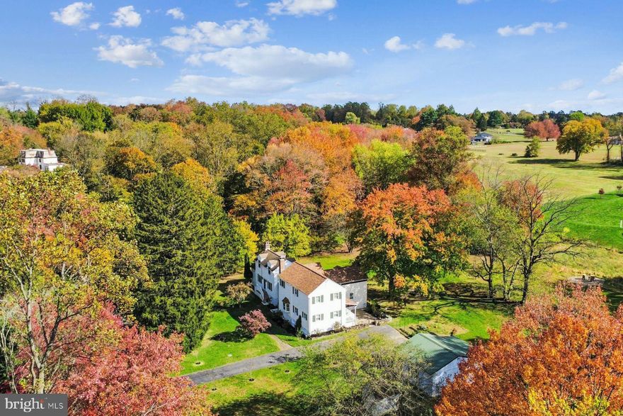 Set upon four tranquil acres in sought-after Glen Mills, 1554 Meadow Lane stands as a rare historic stone farmstead seamlessly reimagined for modern living.

This historic 1766 stone-core home sits on land documented as part of the William Penn “First Purchasers” patent, granted to Joseph Baker in 1681, when the region was still part of historic Chester County.

Located on 4 private acres, the grounds feature mature hardwoods and conifers, multiple varieties of producing apple and pear trees, as well as various edible berries. Rolling meadows and open usable land support homesteading, gardening, livestock, beekeeping, conservation, or private retreat living. The rear meadow is intentionally maintained as a pollinator habitat and active apiary.

The land includes wooded walking trails and multiple natural springs, including a rare armored spring system preserved in the basement, which has reliable supplied water to the home almost 260 years. A backup well exists but has not been needed, underscoring the resilience of the original water source. An abundant ecosystem thrives here, with 75+ documented bird species, deer, fox, and diverse wildlife. 

Inside, the home retains meaningful traces of its 18th-century origins, including sections of original plank flooring, exposed stonework, fireplace, and preserved spring infrastructure--subtle but significant reminders of its early American craftsmanship and purpose. 

Thoughtfully expanded through additions (approximately 1970 and 2000), the home now offers 3378 sq ft, 5 bedrooms, 2.5 bathrooms and 3 fireplaces (1 wood stove and 2 wood-burning masonry fireplaces). The two-story in-law style wing with separate entrances features a full kitchen, en suite bedroom, and private living area with fireplace--ideal for multi-generational living, an au pair/nanny suite, home office, or long-term accommodations.

Recent upgrades enhance efficiency and daily comfort, including a renovated main kitchen, new appliances in both kitchens (one with an induction stove), 3-zone mini-split, smart thermostats, NEST smoke and CO detectors, PEX plumbing, a new electrical panel, and a smart hybrid heat pump water heater. 

An oversized two-car garage with electric provides exceptional space for storage, equipment, workshop use, or hobbies.

With township review, the acreage may also allow future subdivision potential (buyer to verify feasibility), providing long-term optionality and flexibility. 

Located in the award-winning Rose Tree Media School District, the property offers privacy without isolation--just minutes to West Chester and Media, and approximately 30 minutes to Philadelphia or Wilmington, with convenient access to dining, cultural destinations, parks, and major travel routes. 

A unique offering blending historic character with modern comfort and flexibility in a private natural setting. 

Seller is a licensed Realtor ® in Arizona.