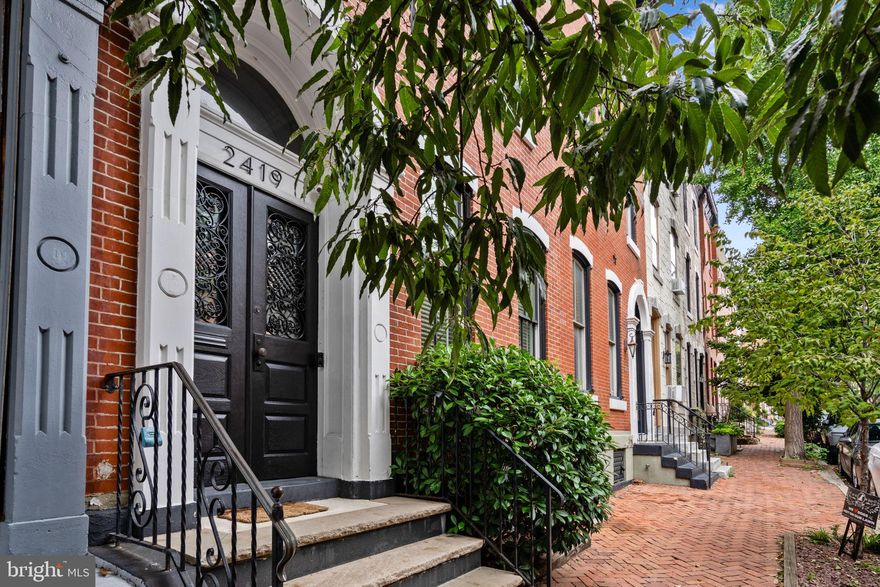 Welcome to the epitome of contemporary luxury living at 2419 Spruce Street. This stunning 4-bedroom home with a den features 3 full bathrooms, 2 powder rooms, a 2-car garage, a patio and a roof deck, making it an urban oasis on one of the best blocks in Fitler Square.  This street-to-street property is just steps from the Schuylkill River Park and Schuylkill Bike Path.  This home was lovingly renovated in 2014 by the owner along with Canno Design architects, and they didn’t miss a beat.  This historic 200+ year-old home boasts 4,200 square feet of living space plus an additional 300 square feet of gracious outdoor space, offering the perfect blend of modern amenities and classic charm.

As you step through the front door, you're immediately struck by the remarkable detail and thought that went into the restoration and renovation of this unique property.  The main floor boasts 11-foot ceilings, a gas fireplace, and a seamlessly flowing open living space that leads to the chef's kitchen. Indulge your culinary senses with top-of-the-line Wolf appliances, a Subzero refrigerator, custom two-toned cabinetry and honed marble countertops.  Additionally there is a first floor den sandwiched between the kitchen and the rear patio that could also be used as a formal dining area. The rear wall of the first floor contains a full floor-to-ceiling glass acordian door that offer the option for seamless indoor/outdoor living. 

The primary bedroom suite on the second floor is a true sanctuary. It showcases a spacious walk-in closet and a custom-fabricated walnut bed frame with integrated side tables, outlets and an incredible array of hidden storage amenities— including a built-in vanity with pop-up mirror and lighting behind the bed! The en-suite bathroom is a spa-like retreat with radiant heated floors, a Victoria + Albert 72" floating tub, and a private water closet. This level also features a spacious and intimate upstairs den with a well-appointed powder room and a conveniently located hidden laundry room. The powder room features a handpainted french wallpaper mural and a custom white concrete sink. 

The third floor houses three bedrooms, one with an ensuite bath, a kitchenette and another gracious full sized bathroom.  Each bedroom offers its own unique character and ample storage thanks to custom closet systems throughout. The hall bathroom is a statement of elegant and playful design with a custom grey walnut vanity, Cole & Sons "woods" wallpaper, and thoughtful touches like a laundry chute connected to the hidden laundry room on the second floor.  The kitchenette features custom cabinets to match the first floor and includes a mini-fridge, microwave and sink for lifestyle conveniences.

The true pièce de résistance of this property lies on the two-tiered roof deck. It's not just a rooftop space; it's a private oasis in the heart of the city. The panoramic views of Philadelphia are simply unmatched, offering the perfect setting for hosting gatherings, admiring sunsets, or sipping your morning coffee. With outdoor speakers, Trex decking, and artificial turf, this space is a versatile canvas for your personal style.

The covered two-car garage offers an accessible ramp to the patio and is housed by a weight bearing structure for the (permit-required) ready addition of another potential outdoor space. 

The unparalleled location of the home offers a vibrant, family-friendly atmosphere and a wealth of amenities. You'll be within walking distance of the city's finest dining, shopping, and entertainment options. The property is a stone's throw away from Schuylkill River Park and boasts easy access to the city's top schools, universities, and hospitals. This home is a testament to modern luxury, combining the allure of historic charm with the conveniences of contemporary living. 2419 Spruce Street is not just a home; it's an opportunity to experience the best that Philadelphia has to offer.