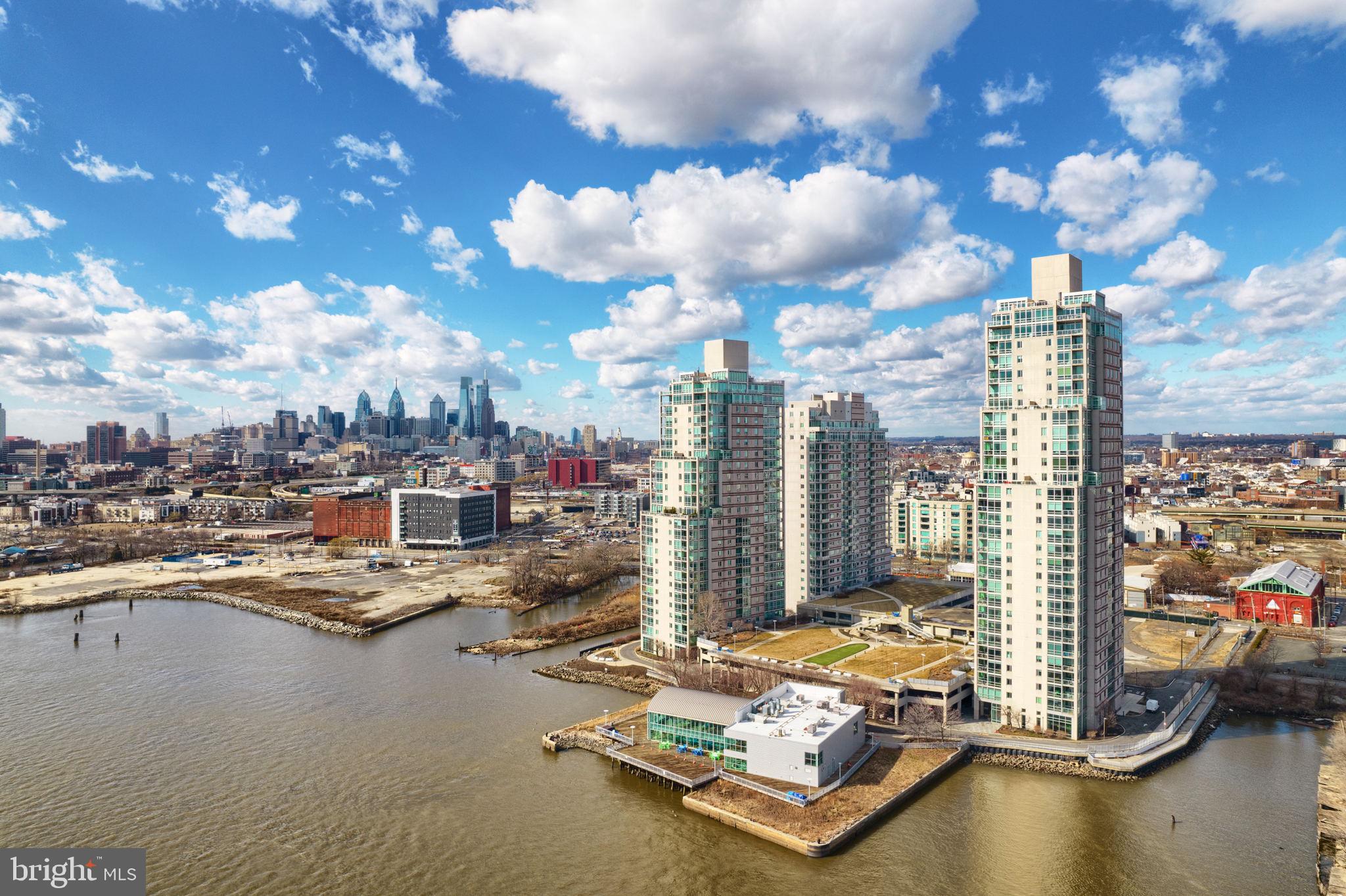 "Size Does Matter" This penthouse condominium at Waterfront Square, boasting over 6500 square feet, is one of the most elegant and desirable residences on the East Coast. It truly offers the "Baller Lifestyle" These combined units housing 5 bedrooms, 6 full and 2 half bathrooms is a breathtaking property. Commanding the entire 24th floor with 360 degree views of Philadelphia and the Delaware River, it has a private elevator lobby, custom double entry doors which lead into an enormous great room with panoramic views of the City and the Ben Franklin Bridge. The adjoining dining room can seat up to 16 guests in elegant comfort and the chef's kitchen with all Viking appliances, double thick white Caesarstone countertops for miles, back lit solid wood cabinetry and an island large enough for an entourage. There is also a family room with exquisite views. The 2 outdoor terraces are perfect for viewing fireworks, or just adorning the city skyline. The palatial primary suite is the ultimate haven of luxury with an intimate living area, his and hers marble bathrooms and two huge walk-in dressing room closets. One of the 5 bedrooms has a living area and kitchenette-which could be used as staff quarters, with it's own private entrance. It has gleaming hardwood flooring throughout the living spaces, and classic Carrara marble tile in the bathrooms. There is surround sound entertainment in every room. It also comes with 2 storage units and 4 parking licenses. Waterfront Square Condominiums is an elegant, gated community offering a round the clock guard and gate, as well as concierge service, valet parking, olympic size pool and hot tub, a state of the art gym including a sauna and steam room. There are also community/ meeting rooms in every building available for residents .The massive multi tier garage is roofed with Philadelphia's largest green roof and even includes a putting green! This enclave resides on a 9.5-acre parcel, with lush manicured fauna and it borders the Delaware River. There is on site management, security, and a shuttle taking residents all throughout Center City and as far as the train stations. If you are looking for the ultimate in luxury in a completely secure complex , offering the finest views in Philadelphia, adorned with amenities, then look no further!