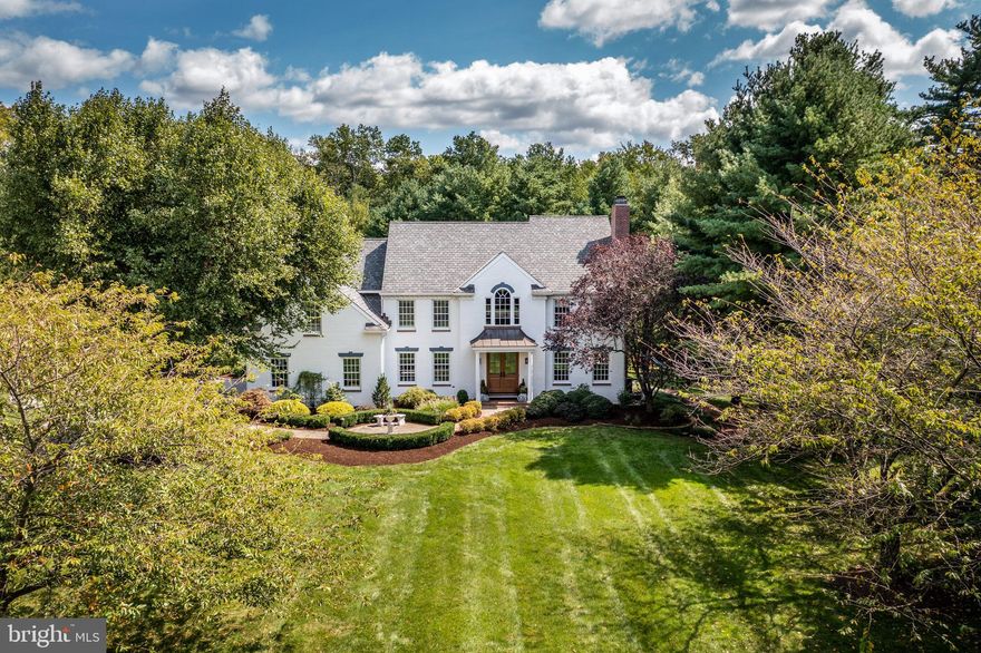 The beauty and elegance of this home in Malvern, located in the community of Fox Ridge, is hard to overstate. Situated in a lush, private setting with mature landscaping, this private oasis has a gorgeous, inground pool. The interior of the renovated, meticulously cared-for home, with its gracious touches including a Palladian window, hardwood flooring, and two fireplaces, is welcoming and lovely. And, with a newly renovated exterior, including roof and Hardie plank siding, it is built to last. The home’s location, within the excellent Great Valley School District and close to all major thoroughfares and the town of Malvern, couples warmth and beauty with an ideal setting.  A beautiful and expansive lawn leads to the front entrance and its two-story, dramatic foyer, with marble floor. The formal living room, with its custom millwork, white-mantel fireplace, and oak flooring, flows into the dining room via French doors. Also a lovely space, the elegant dining room has oak flooring, large windows, and a stunning, coffered ceiling. The home’s kitchen overflows with numerous upgrades, perfect for beginner cooks and experienced chefs alike. Special amenities include a six-burner Wolf stove and quartzite countertops. It is a gorgeous room to behold, with its black walnut center island with bar seating and complementary dining nook. Special cabinets with unique hardware, as well as distinctive backsplash and lighting, are wonderful touches. The open kitchen flows seamlessly into the family room, with its cathedral ceiling, white brick fireplace, pretty floors, and large windows. The first level has a powder room as well as an office, with large windows and hardwood floors. The laundry/mudroom has access to the three-car garage. From the center hall, a gracious staircase leads to the second level: a well-planned space with a main bedroom and bath, three additional bedrooms, and two renovated, beautiful hall baths. The main suite is a luxurious retreat, with its sumptuous, en-suite bathroom as well as a walk-in closet. The bedroom, which has a grasscloth ceiling, has beautiful, custom built-ins with a gas fireplace. The white-tiled bath has a double vanity, glass-enclosed shower (zero entry) and separate tub, topped by three windows. The four additional bedrooms on this level are spacious, sharing two full baths. One of the baths has a dramatic, subway tile oversized shower and double vanity, and two of the bedrooms also have custom millwork. The lower level, with its abundant fun spaces, is the perfect place for entertaining, whether it’s game night with friends or other activities. The custom, brick-floored bar is topped with an eye-catching tin ceiling, while the high-end, knotty alder cabinets add panache. The wine refrigerator and wet bar are ideal for fun parties. This level also has a gym area and space for additional storage with an egress window to the outside. Entertainment possibilities flow to the private, fenced-in backyard and in-ground, heated, salt-water pool. The two-tier, flagstone patio is gorgeous, while the pool’s dramatic, flowing water is artistic and well suited to the landscape. There is a separate seating area and pergola adjacent to the pool. Both the front and rear yard are irrigated, and landscape lighting surrounds the property. The three-car garage provides ample space for vehicles and storage.With its parklike setting and amazing grounds, you might forget how ideal the home’s location is: close to the towns of Malvern and Paoli, with shops, restaurants, and public transportation. You also are just minutes away from Applebrook Golf Club and Natural Lands’ Willisbrook Preserve.