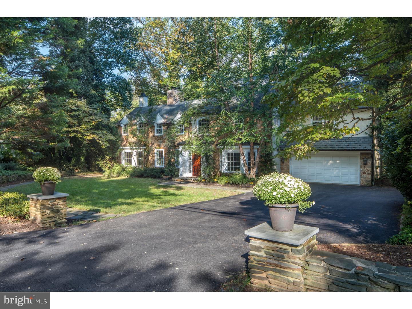 Impeccably maintained, renovated & re-landscaped stone & stucco gem with all the luxuries one seeks in modern homes along with the charm of a classic Main Line Colonial. The secluded location in the heart of Bryn Mawr is incomparable, set on the less-traveled section of Old Gulph Rd with a stone wall & privacy trees isolating you further. The house is perfectly positioned to take advantage of lovely views of Mill Creek which meanders through the grounds. Sit on the rear patio in summer & enjoy total tranquility, while the little ones fish in the creek or play in the backyard. The flagstone path that wraps around is great for walking, jogging & riding bikes or scooters. There's also a zip line which goes over the creek! Built in the 1960's, the home was gutted & redone in 2005, with new electric, appliances & Grand Manor shingle roof, copper gutters, etc. Care was also taken to waterproof with a French drain installed in the front yard keeping the basement bone-dry. An elegant center hall foyer w/coat closets & powder room whisks you into bright, airy living space enriched by hardwood floors & decorative moldings. Though an opening at left is the living room w/fireplace flanked by built-ins, offering scenic views & doors to the rear patio. To the right is a dining room w/a bay window & glass-paneled door to the kitchen for seamless entertaining. Much time will be spent in the kitchen/family room w/mesmerizing views. The cook always feels part of the activity with the family room connected to the spacious kitchen appointed w/granite countertops, built-in appliances, a dining island & breakfast room. Double doors proceed to the mudroom entrance w/powder & laundry rooms + entry to the 2-car garage. A den/office with coffered ceilings, gas fireplace, bay window, surround-sound entertainment center & patio door is a comfortable place to unwind. The hardwood 2nd floor presents 3 bedrooms, a hall bath & divine master suite with a balcony, fitted closet & spa bath w/a sky-lit shower, soaking tub & dual sink marble-top vanity. Closet ladders in BRs 2 & 3 ascend to the "secret" finished attic space, a tent-shaped play place w/skylights! A finished 3rd flr BR suite w/a bath are B&B-like quarters facing the creek & grounds. The finished basement has generous rec & storage space. Two patios look down on Mill Creek & are ideal for large parties. Prime location next to Harriton Park. Easy walk to the train station, Bryn Mawr & Bryn Mawr College on quiet Millbank Rd!