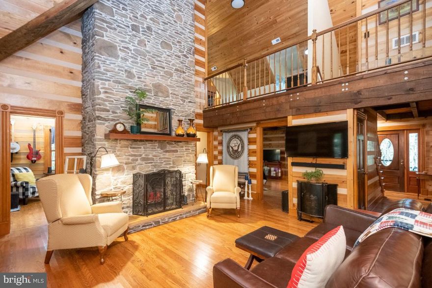 Nestled amongst the trees on almost six acres is a custom log cabin that is beautiful and serene.  The rustling you might hear could be the crackling of the wood burning fireplace that boasts a breathtaking field stone chimney from floor to ceiling that could be found in your favorite ski lodge.  The vaulted ceilings, several French doors and a Dutch door that has a private entrance, creates a sense of wonder and joy as you take in the honey colored logs and the gleaming hardwood floors though out the cabin. The wrap around porch invites you to put your feet up, read a book or enjoy the the tunes of variety of birds that often make their nest in the clothespin bag on the clothesline.  There are many trees in which to hang a hammock and enjoy the sights and sounds.  There are two large master bedrooms, a cozy loft area, a separate dining room, first floor laundry and a finished walk out basement.  Outside is a paved walkway from the basement to the front of the house flanking the landscaping.  Make sure to bring some marshmallows, there are plenty of sticks in the woods, to enjoy the outdoor fire pit.  This log cabin is tucked away as a private retreat but close to all the amenities and conveniences Westminster has to offer.  The home has been meticulously maintained by the owner who recently had the driveway paved and a new roof installed.  Come see for yourself at the Open House on Saturday,  October 30th from 12-3!