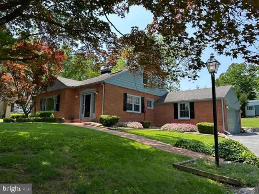 Charm and Location! One year home warranty included!

Cozy and classic lovingly maintained for over 20 years 5 bedroom 2 ½ bath all-brick home located in the desirable Fountain Head neighborhood with golf course views! This home shows like new and it’s in move-in condition. Recent updates include replacement windows, new neutral paint, new LED lights, refinished hardwood floors, upgraded faucets, new receptacles and light switches, new door handles. The recently repaved driveway runs along the beautiful and professionally landscaped front yard and ends next to the oversized garage and a stone wall bordering the backyard, which features a large custom-build shed for your extra storage needs. You can enjoy the private backyard with mature trees while soaking in the relaxing jacuzzi tucked under the spacious covered rear porch. Once inside the home, you are greeted by beautiful hardwood floors and abundant natural light from the double windows in the dining room which flows into the living room, equipped with a wood-burning fireplace featuring a delicately detailed mantle and well-appointed picture window. Three bedrooms with large closets and a full bathroom with custom tile work are located off the living room. The kitchen comes with upgraded stainless steel Samsung appliances, tiled floors, and a stunning quartz countertop that runs the length of the spacious cabinets, leaving plenty of room for an intimate breakfast nook by the double windows. The second floor offers endless possibilities. It features a beautiful custom designed tiled bathroom with built in storage and an oversized jacuzzi tub that rests beneath the skylight offering plenty of natural light. You’ll find two generous bedrooms with walk-in closets, skylights, and plenty of windows to enjoy the beautiful outdoor landscape. There is also outdoor access to the back porch from the upstairs area including a snug balcony and railed Trex staircase. The spacious semi-finished and just remodeled basement (not included in the quoted square footage) is heated and air-conditioned, and offers an oversized laundry room with washer, dryer and a double wash sink, and plenty of space for a family room, home gym, and storage. This home is a rare opportunity to live affordably in Hagerstown’s most sought-after neighborhood without paying city taxes, yet minutes away from everything.