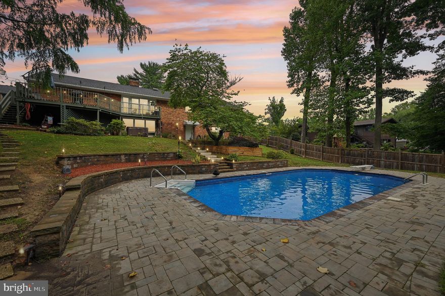 Discover your future in this immaculate 5-bedroom, 3-bathroom home, ideally located for convenience yet offering a serene backyard retreat reminiscent of Narnia. This beautifully upgraded brick rancher boasts an expansive driveway encircling a new garage, complete with 220 electric for all your projects and RV hookups. Step inside through the carport or front door to encounter tasteful decor throughout.

The chef's kitchen features a gas stove and elegant water fixtures, complemented by ample hardwood cabinetry and a cozy bar/coffee area. A spacious living area provides room for relaxation and entertainment, with additional dining space nearby. A quiet wing houses three bedrooms and a stylish main bathroom featuring travertine tile and a luxurious waterfall shower.

The oversized master suite offers a spa-like experience with an extra-long tub and convenient laundry chute, while generous closet space abounds in every bedroom. Step out onto the expansive deck overlooking your private backyard oasis, complete with a heated pool, multiple hardscaping areas, and a lower patio with a jacuzzi.

The lower level boasts an expansive entertainment/game room, two additional bedrooms, a full bathroom, and direct access to the backyard, offering ample space for guests or potential rental income. Additional highlights include a laundry/utility room, workout area, workshop, and plenty of storage options.

Outside, your secluded paradise awaits with garden-ready spaces, a designated area for animals, and a fenced fire pit area. The property is nestled in Hammond Park, providing easy access to hiking, walking trails, and outdoor activities at Odenton Natural Area.

Experience the grandeur and convenience of this meticulously maintained home, where every detail invites comfort and relaxation.